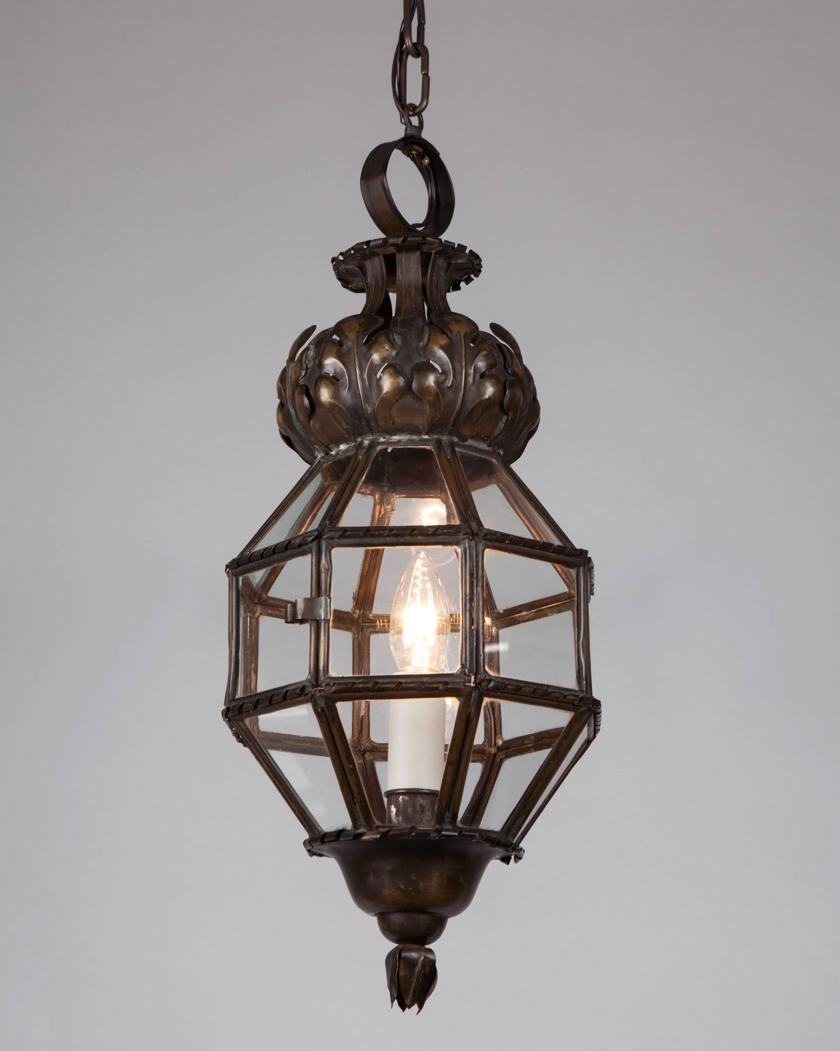 AHL4090
A 24-sided antique lantern with delicate brass framing, repousse leaves, and scrolls, in its original aged brass and bronze patina. Glazed with clear glass panels. Due to the antique nature of this fixture, there may be some nicks or
