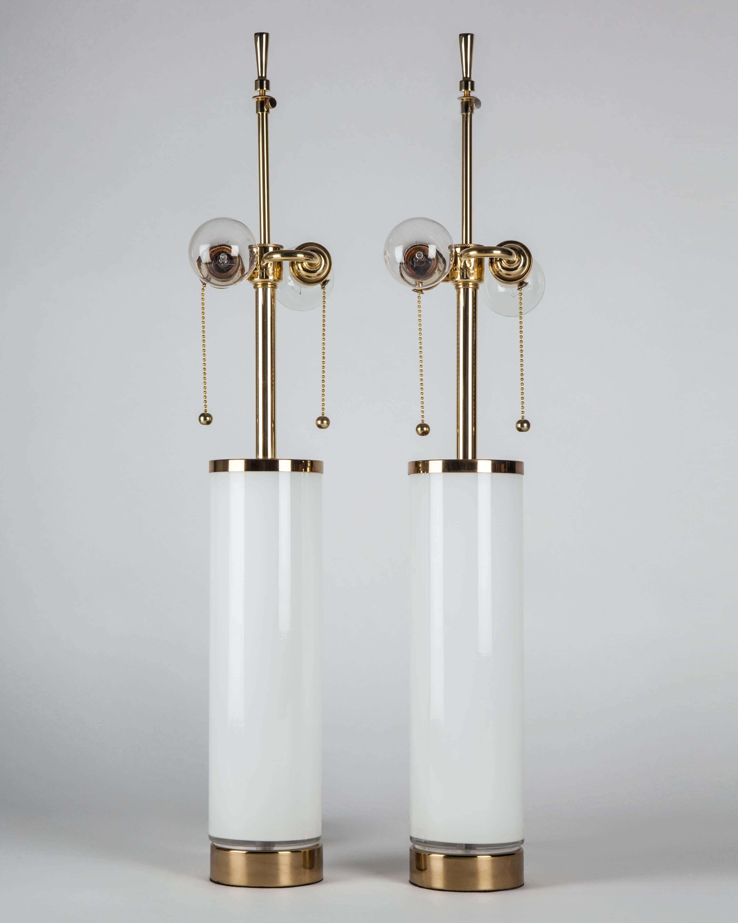 ATL1970
A pair of vintage white cased glass table lamps finished with polished brass fittings. By the Swedish maker Bergboms. Due to the antique nature of this fixture, there may be some nicks or imperfections in the glass.

Dimensions:
Overall:
