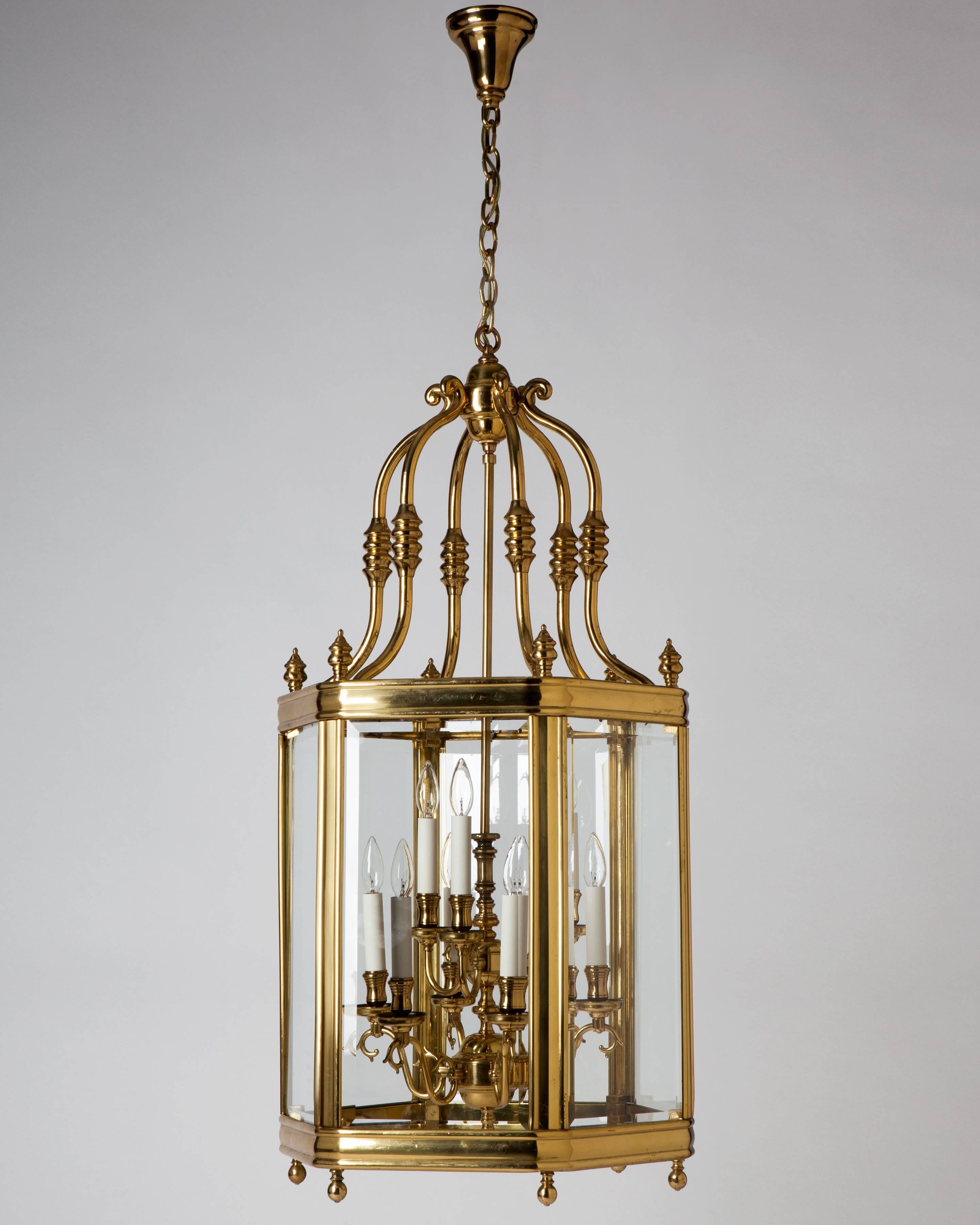 A vintage hexagonal lantern with a nine-light central cluster, all in its original polished brass finish, circa 1950. Glazed with clear bevelled glass panels.

Dimensions:
Current height 85