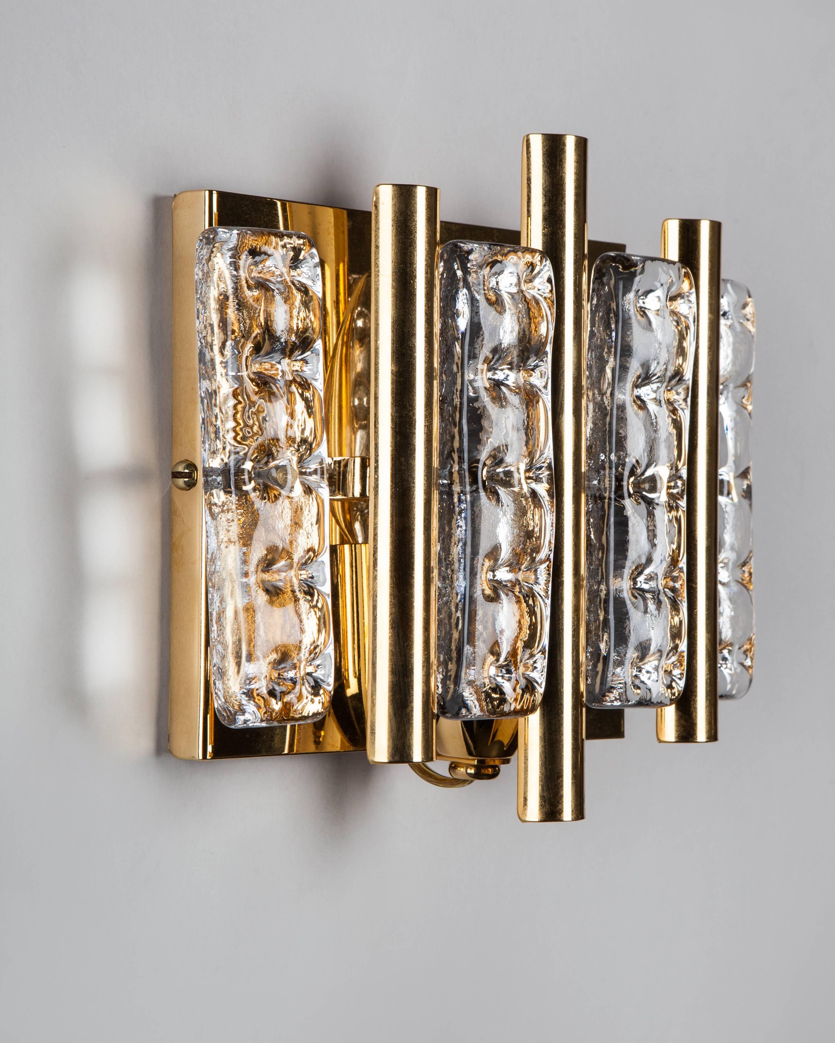 AIS3037
A pair of vintage sconces with dimpled, clear glass tiles on gilded frames. Attributed to the Swedish maker Flygsfors. Due to the antique nature of this fixture, there may be some nicks or imperfections in the