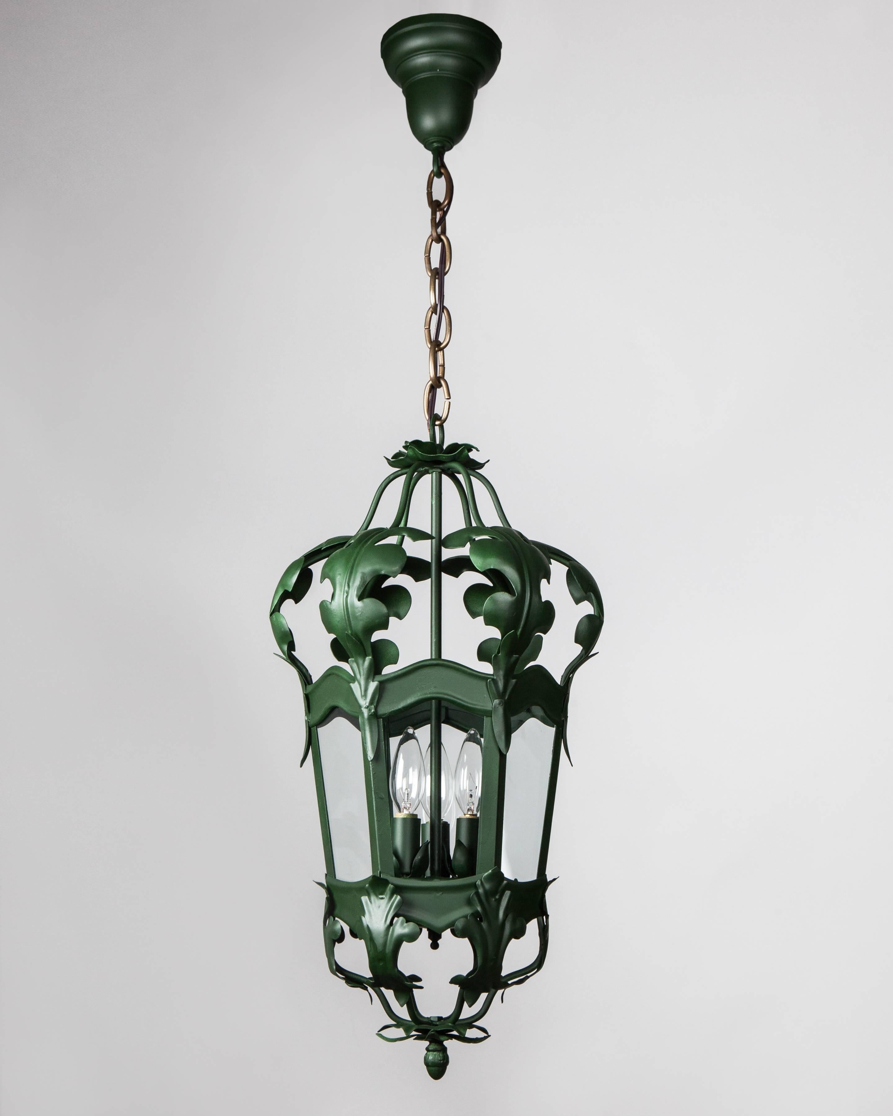 AHL4094
A vintage six-sided lantern with foliate details. In a green lacquered and aged brass finish. Glazed with clear glass panels. Due to the antique nature of this fixture, there may be some nicks or imperfections in the