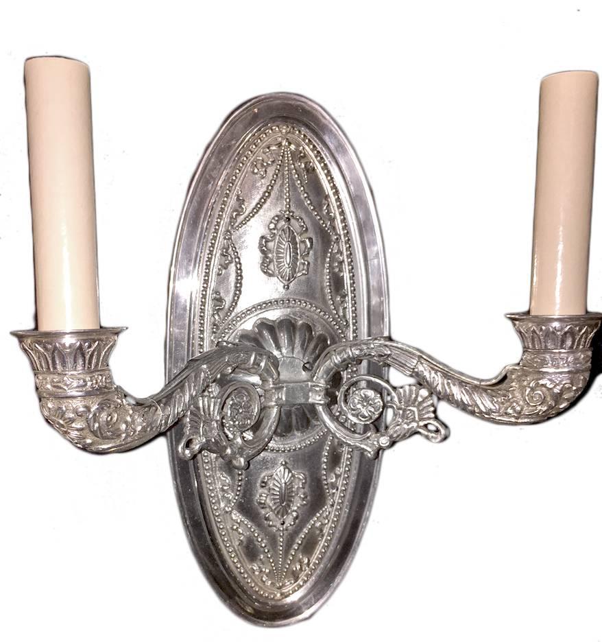 Pair of silver plated double arm French sconces with detailed etched body and arms.

Measurements:
Height: 11.5