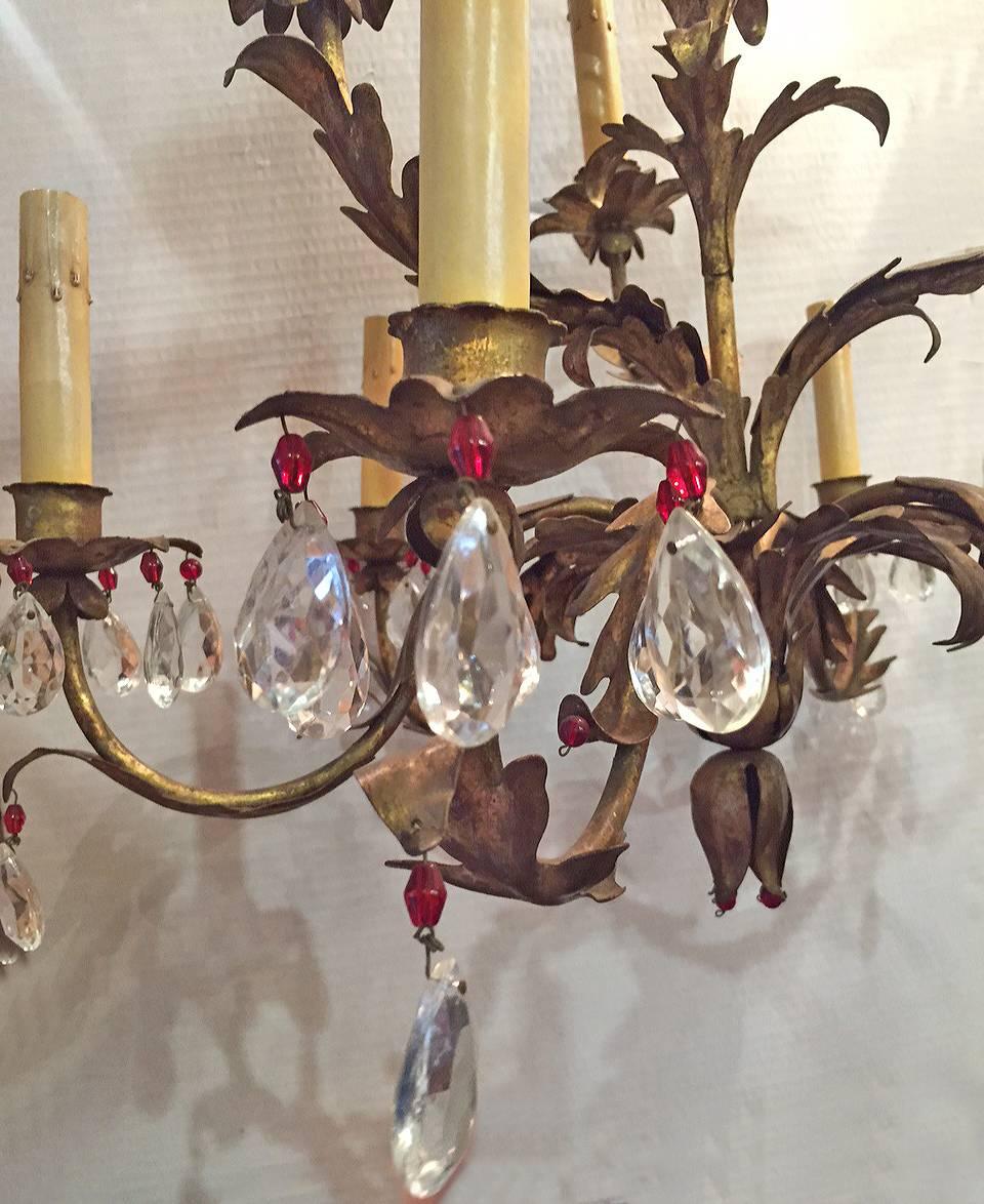 A circa 1940, French gilt metal chandelier with nine-lights, crystal pendants in a foliage motif body. Original patina.

22.5