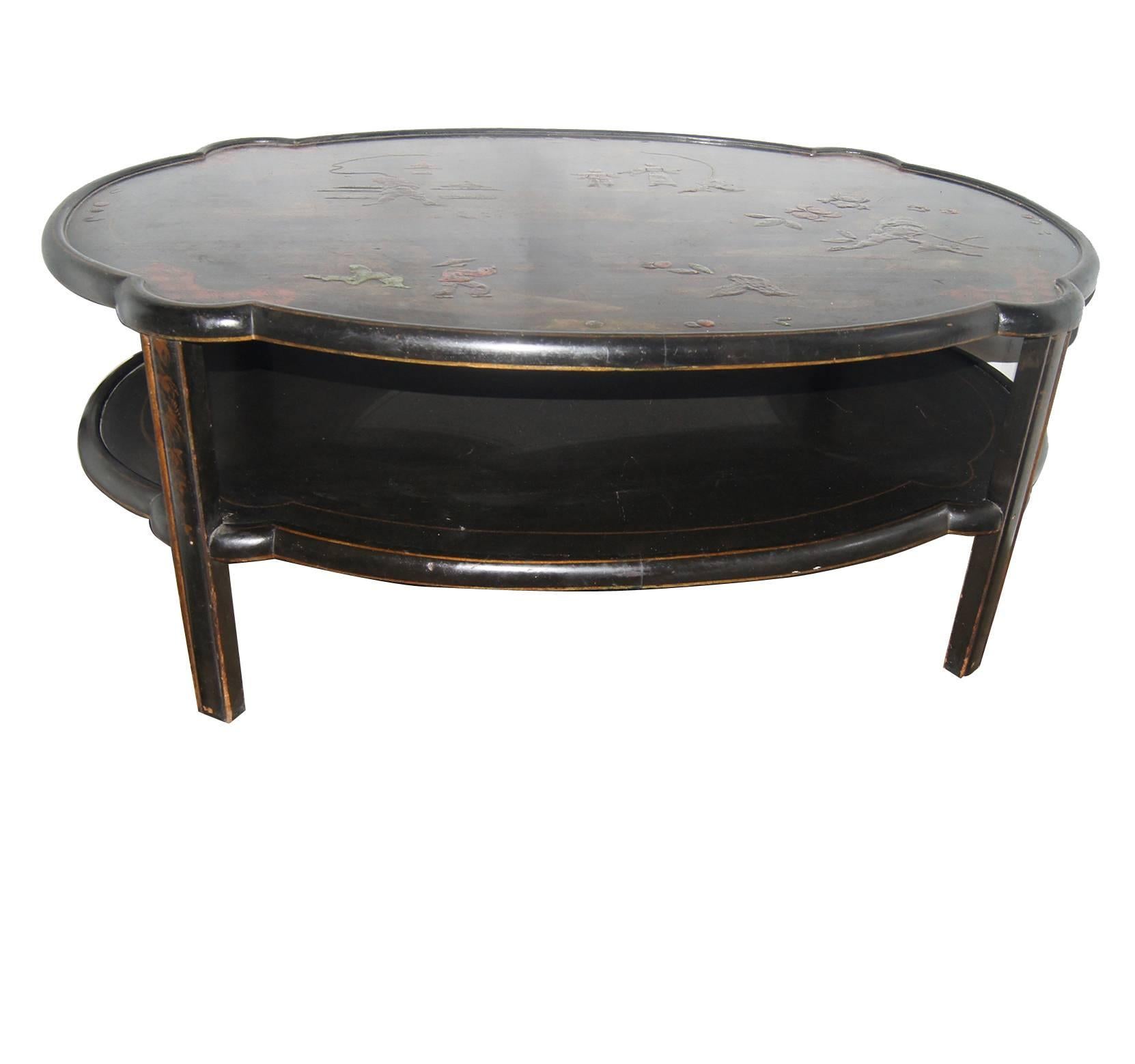 A Chinoiserie painted coffee table with landscapes with gilt details, circa 1940s.
Double tiered.
    