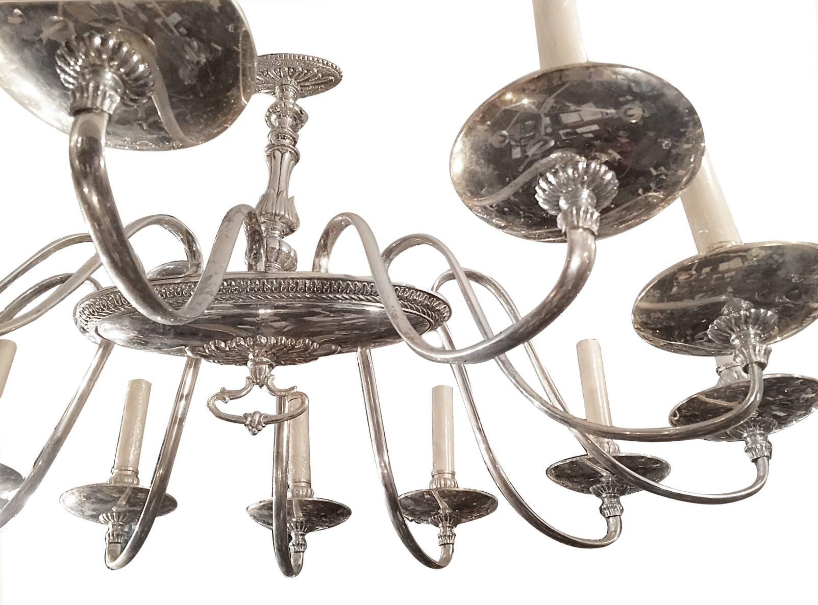 An English circa 1920's Neoclassic style oval twelve-arm chandelier.

Measurements:
Length: 36