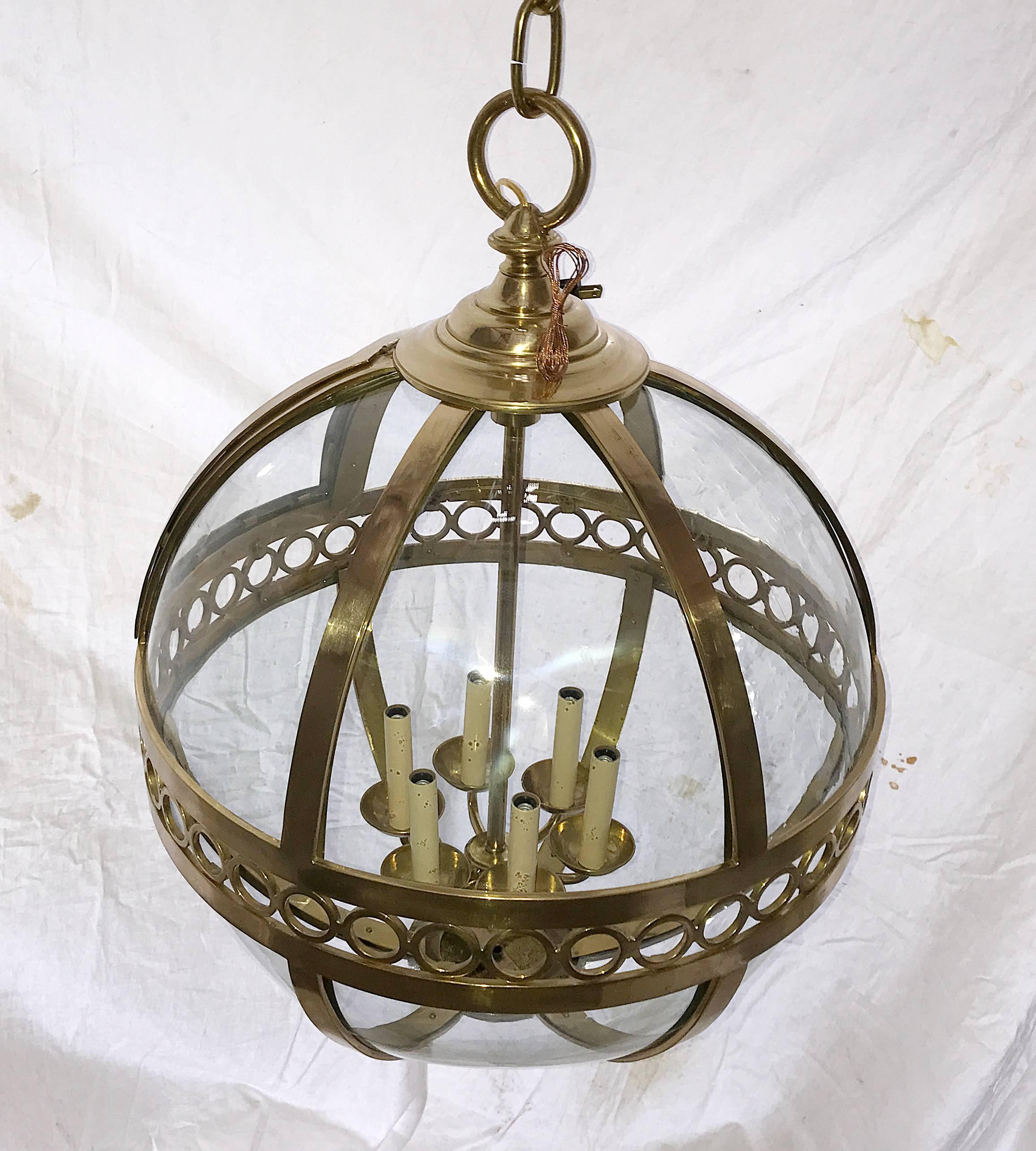 Pair of circa 1950s French bronze lanterns with molded glass insets. Six lights.
Measures: Diameter 24