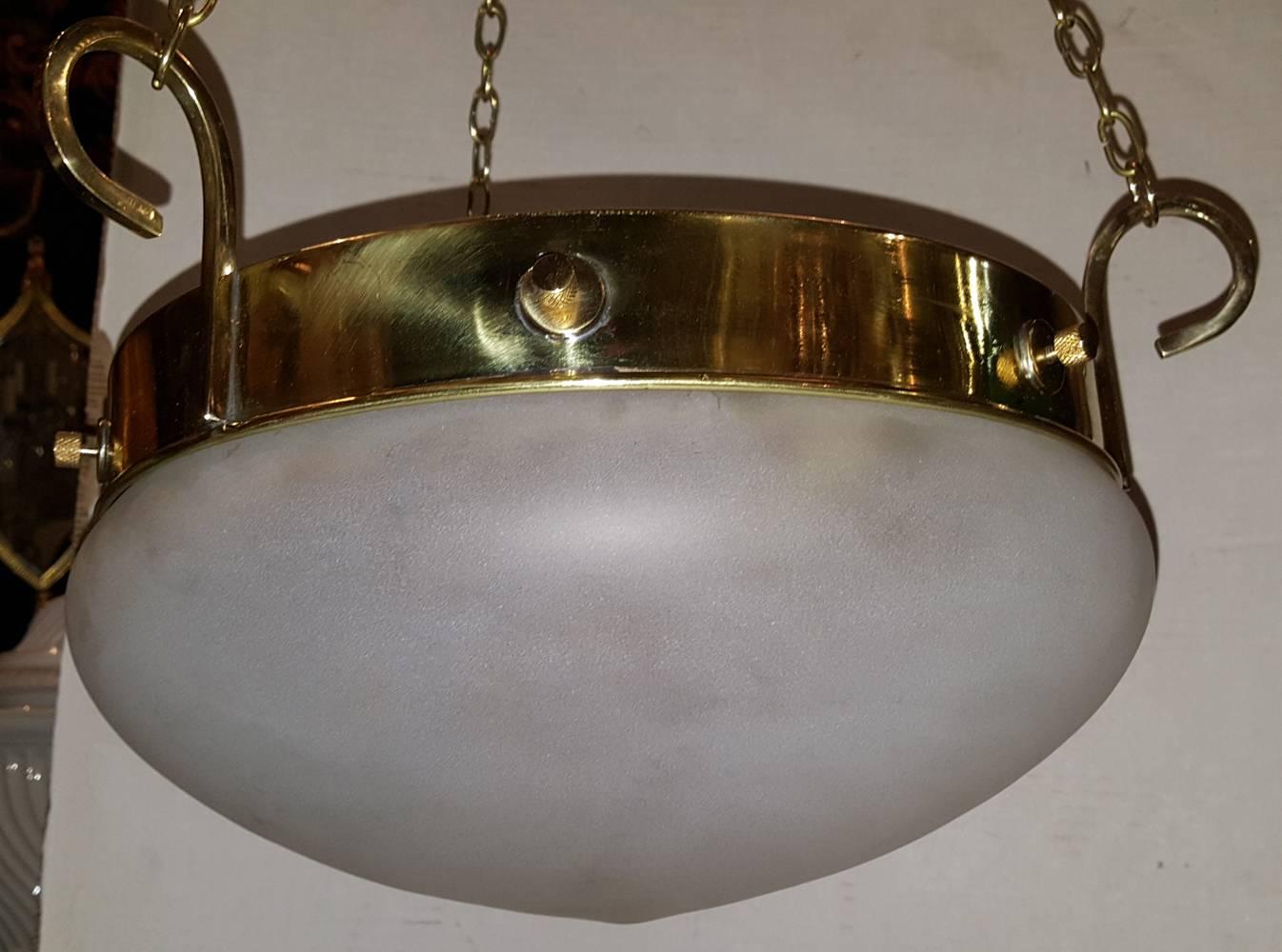 Pair of French gilt light fixtures with frosted glass insets. Two Edison interior lights.

Measurements:
Diameter 14