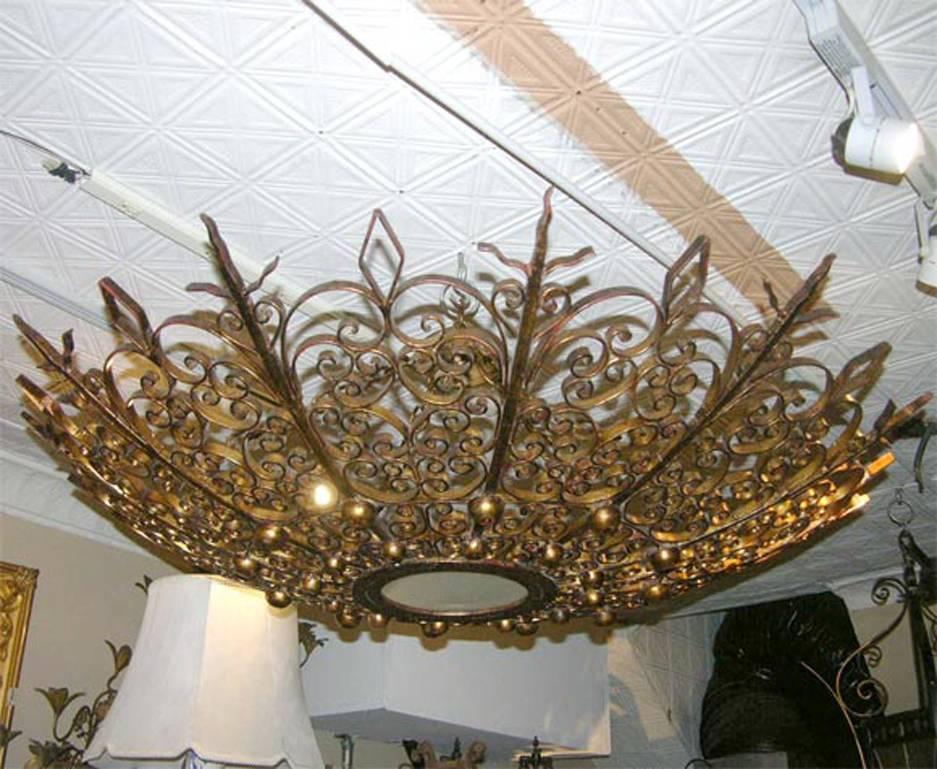 Pair of Large Gilt Iron Sunburst Light Fixtures In Excellent Condition For Sale In New York, NY