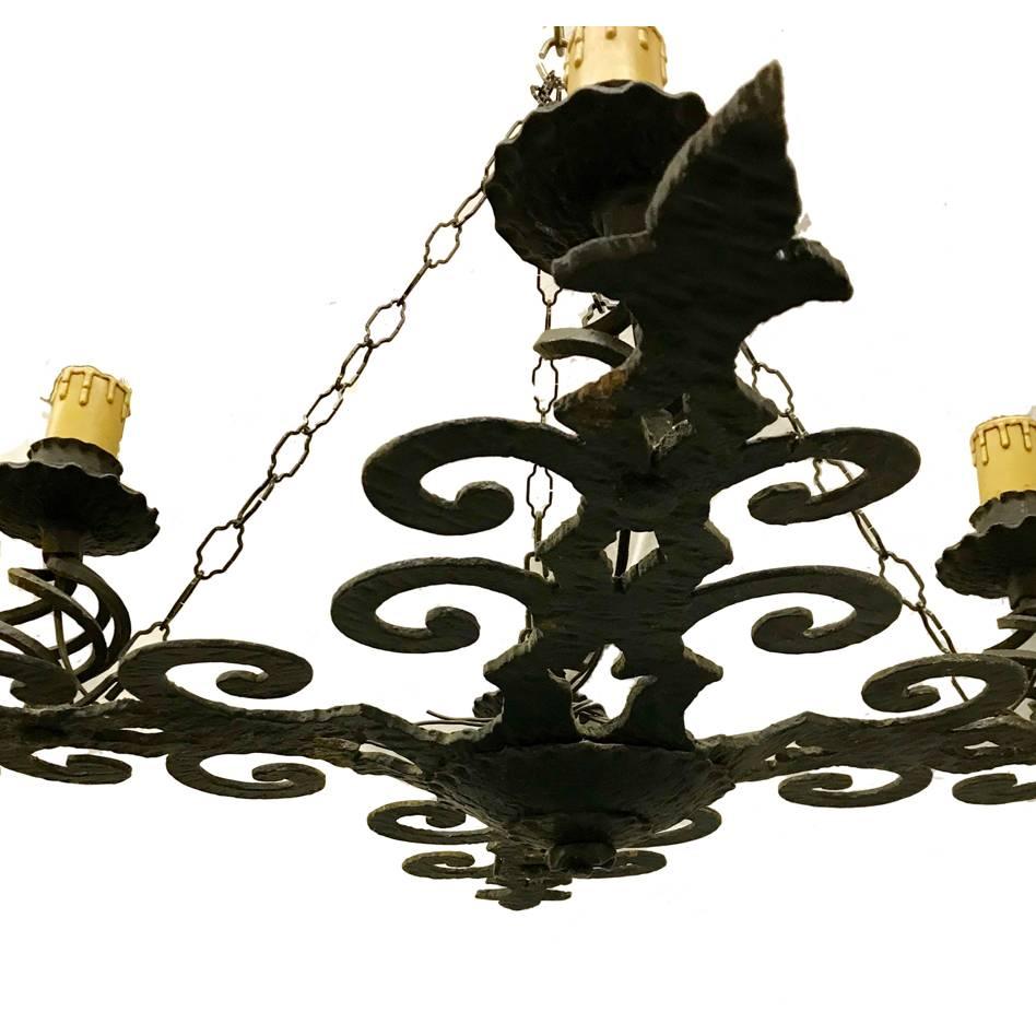 A French wrought iron chandelier with four lights, circa 1930s.

Measurements:
38