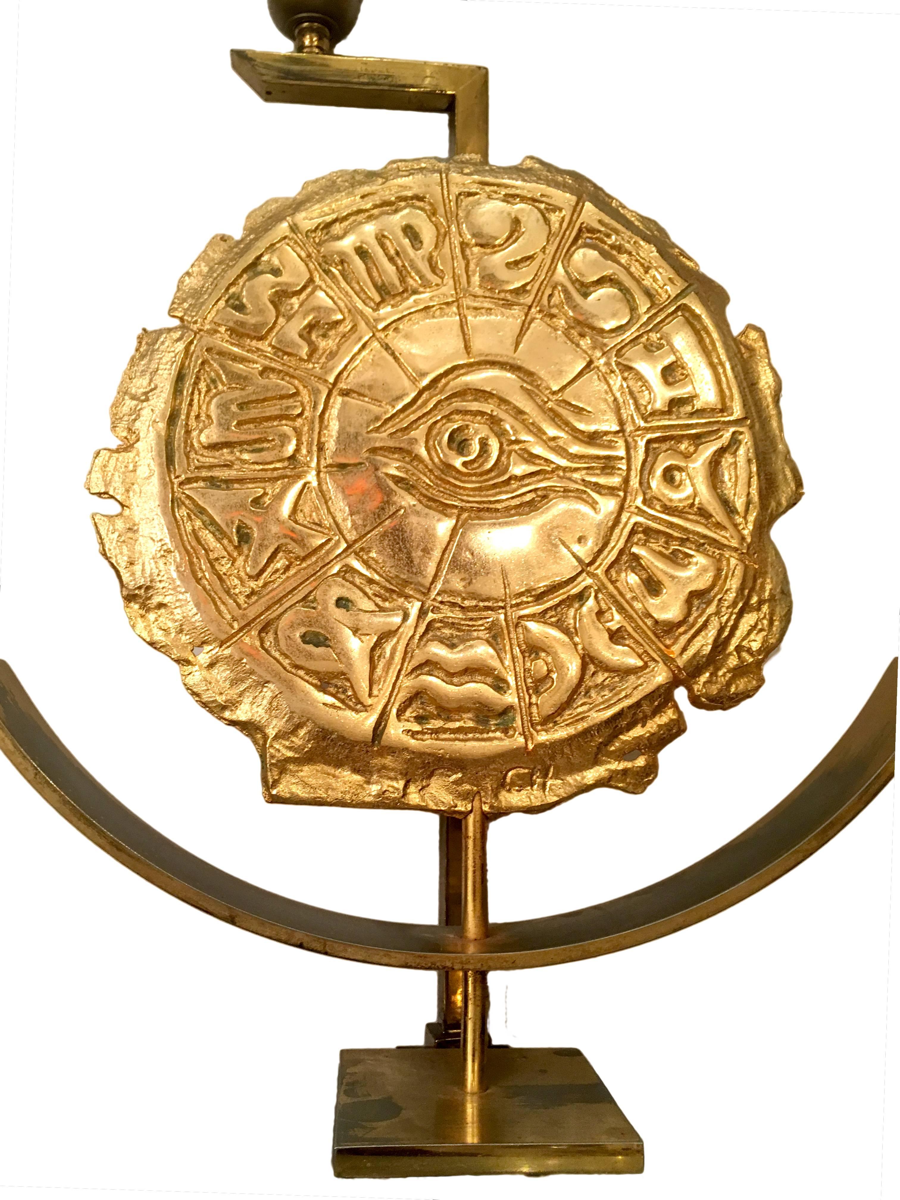 A circa 1960s Italian gilt bronze lamp with zodiac wheel detail.

Measurements:
Height of body: 16