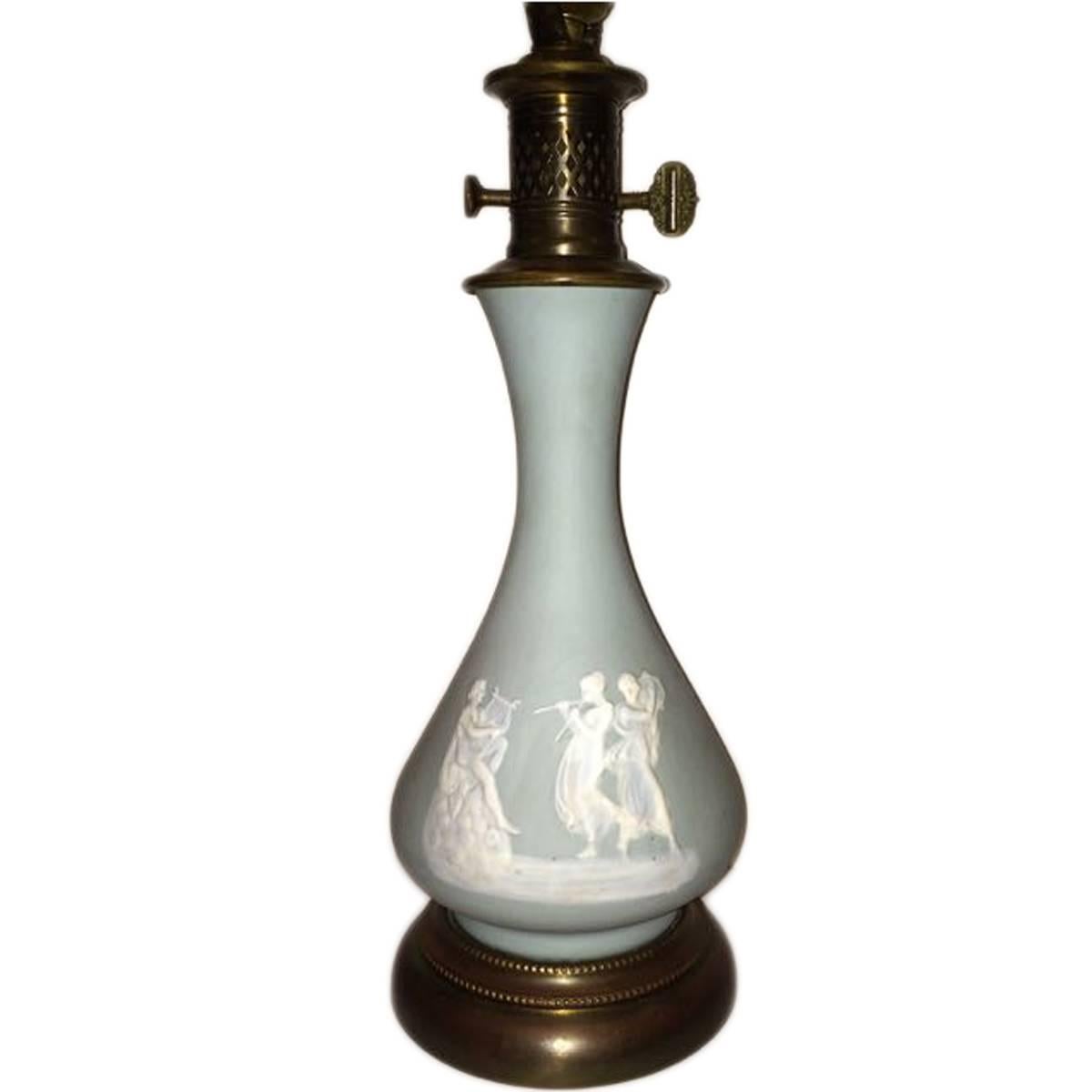 A circa 1920 French porcelain table lamp with pate sur pate neoclassic decoration.

Measurements:
Diameter: 6