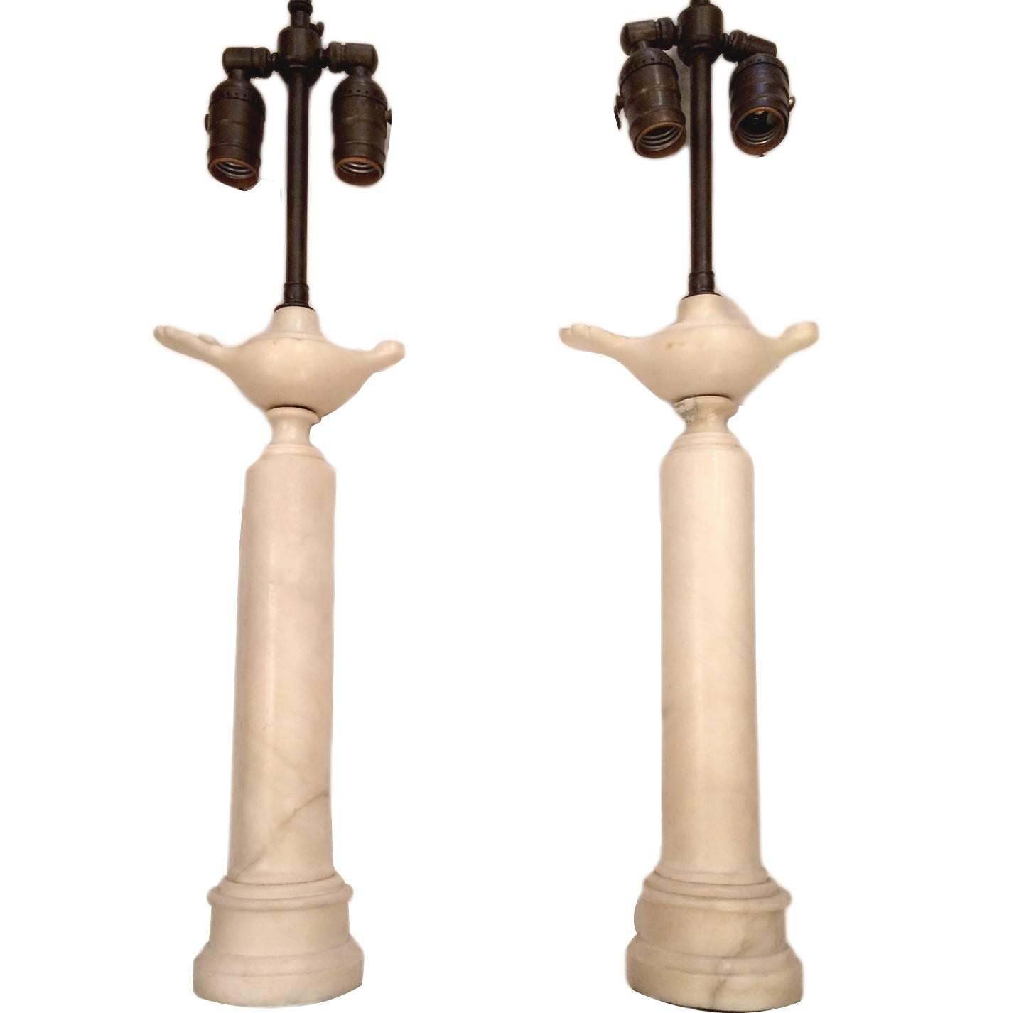 A pair of circa 1920 Italian carved alabaster table lamps in the form of classical oil burners on columns. 

Measures: 16