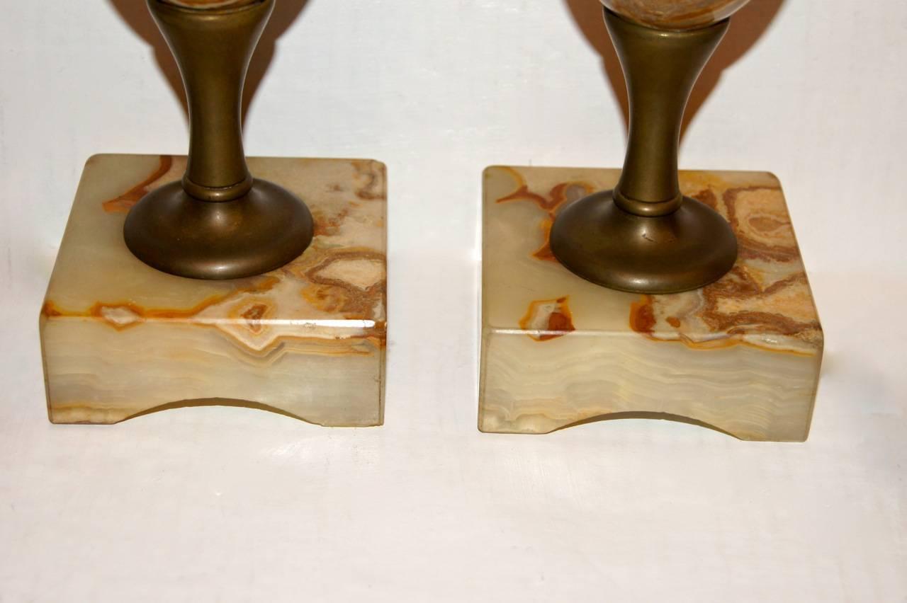 A pair of circa 1920’s Italian onyx and bronze table lamps.

Measurements:
Height of Body: 13“
Height to shade rest: 23“