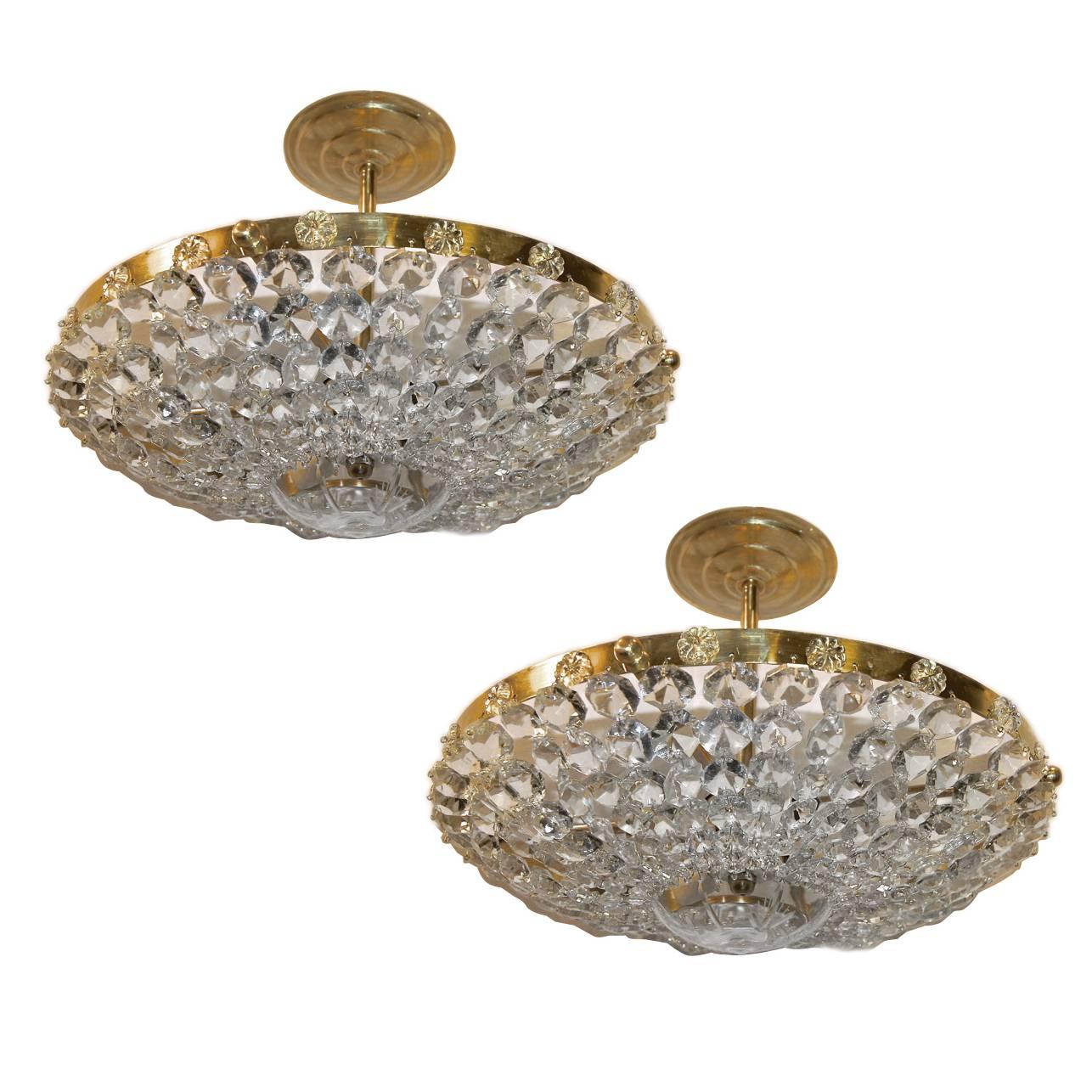 A matching set of circa 1940s French crystal semi flush-mounted light fixtures with 3 interior lights each. The crystals with etched crystal center piece and rosettes on body. 

Measurements: 
Drop: 7.5