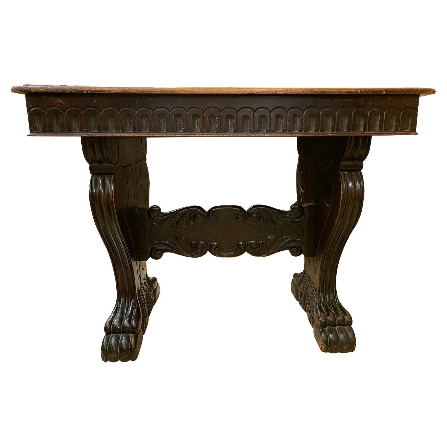 A circa 1900s Italian carved wood side table with lion's feet carving. 

Measurements:
Width 39.5