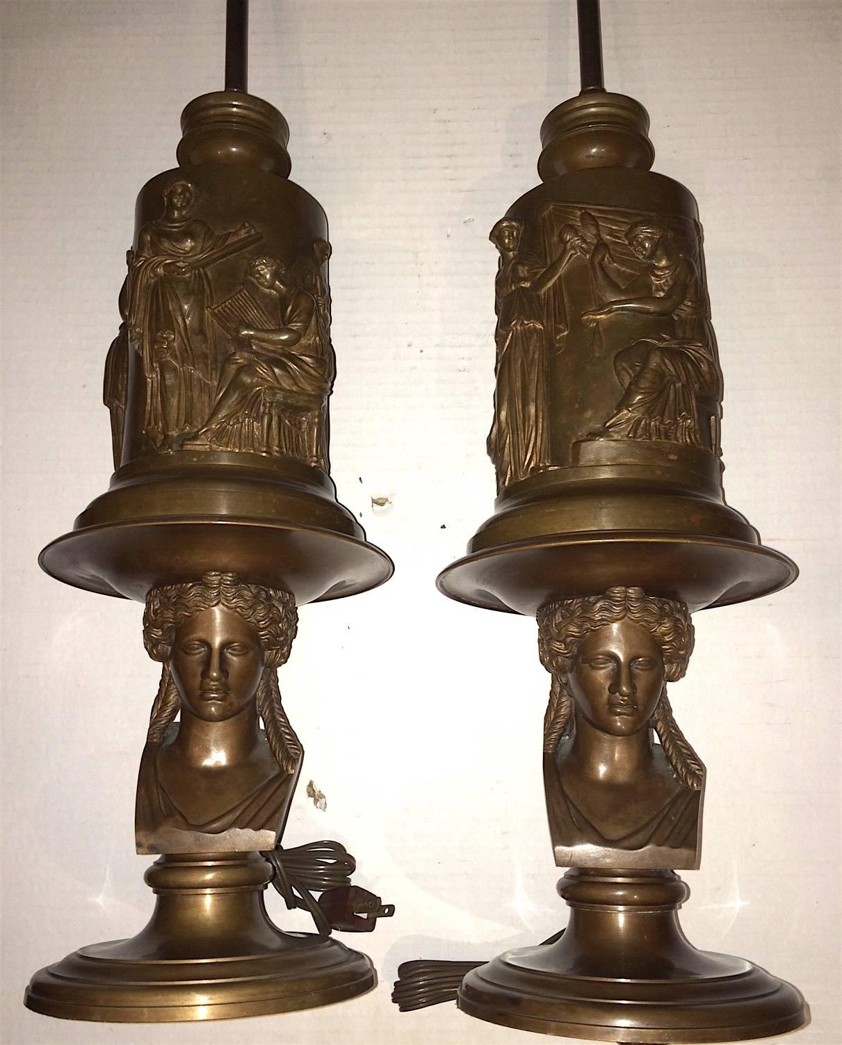 Pair of French, cast and patinated bronze table lamps with neoclassic scenes on body. Bust detail on base. Signed by Barbedienne.

Measures: 22