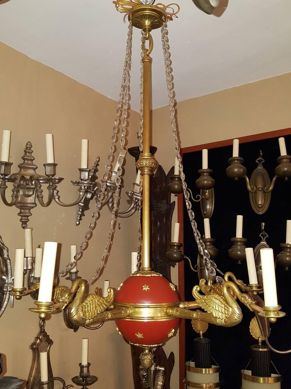 A set of four of French, circa 1900's Empire-style chandeliers with gilt and painted finish. The five arms with finely etched swans and with stars on body. Each sold separately. 
Measurements:
Drop: 41