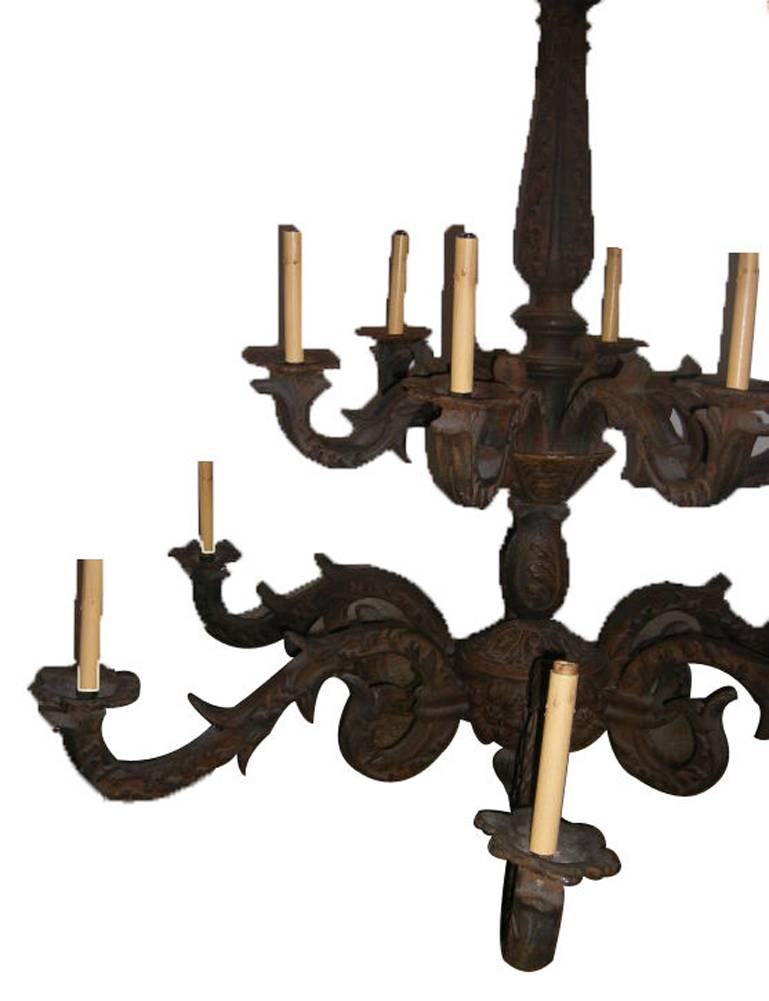 A heavy cast iron chandelier with foliage motif on body and arms. Floral and foliage motif on body and arms, the arms, with original canopy and patina.

Measure: 48