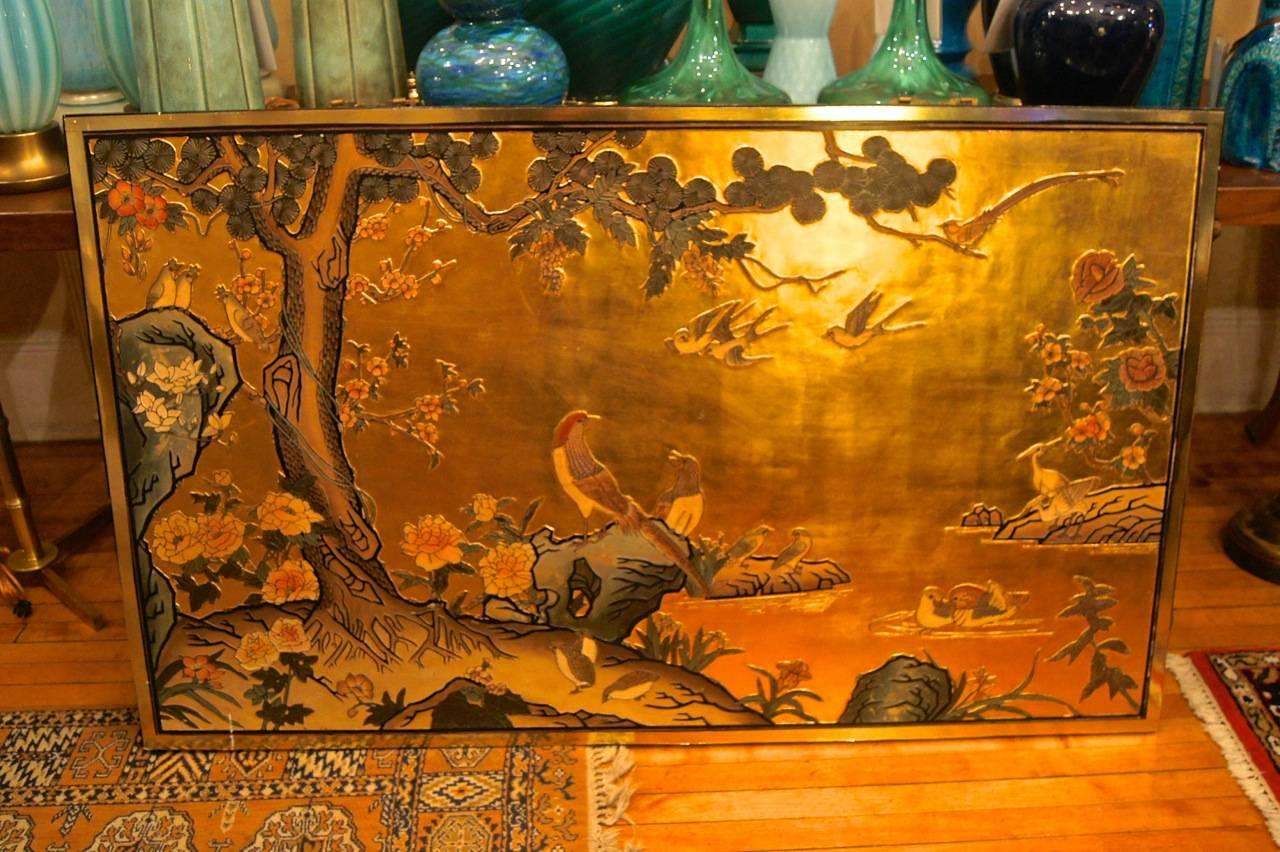 A lacquered and gold painted Chinese decorative hanging panel, circa 1940s. Richly decorated with birds and foliage.