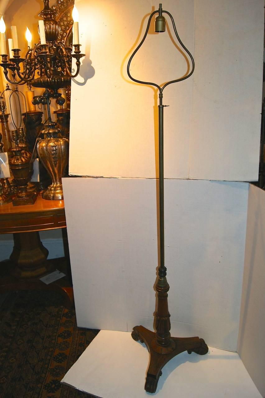 A single, circa 1920s English rosewood and bronze floor lamp with adjustable harp.

   