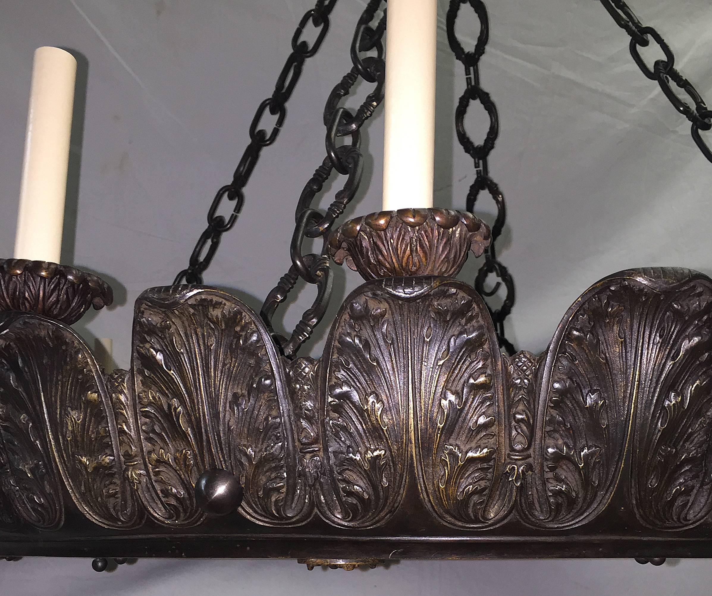 A large 1920s American neoclassic style 16 lights chandelier. Acanthus leaf motif on body. 

Measurements:
Height 30