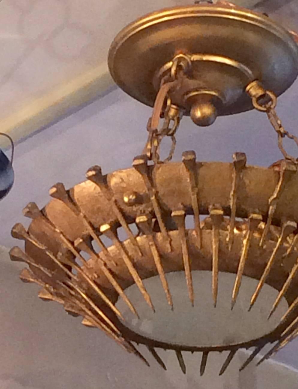 A French circa 1950s gilt metal sunburst light fixture with glass inset.
Two lights. 

Measurements:
12