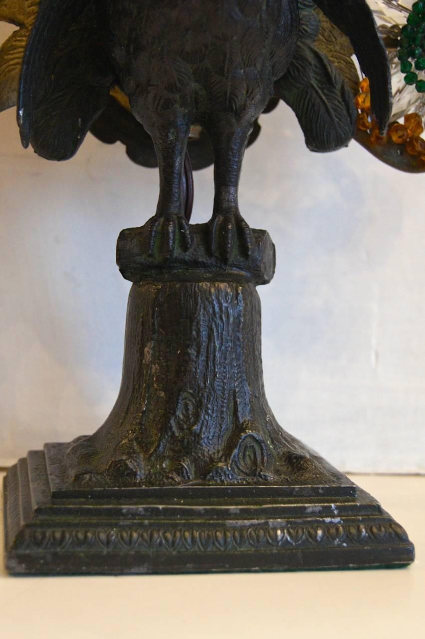 A circa 1930's American bronze cast Peacock table lamp with hand-woven crystal tail with 2 lights behind it.

Measurements:
Height: 16