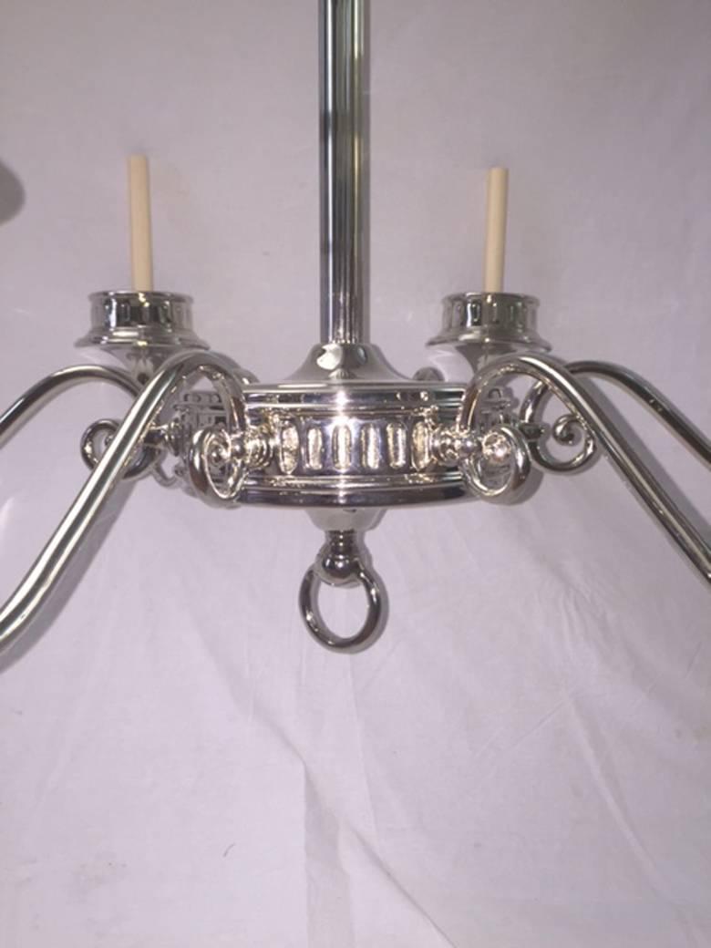 A pair Italian nickel plated chandeliers with six lights, oversized bobeches. Adjustable drop.

Measurements:
36" min. drop, 40" diameter.
  