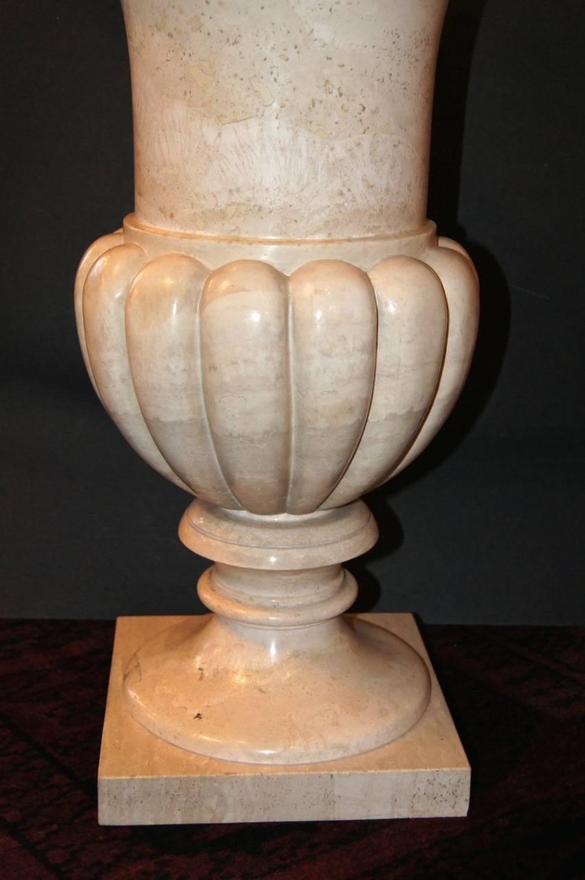 A pair of circa 1940s Italian carved marble urns on pedestal bases.

Measurements:
Height 24.5