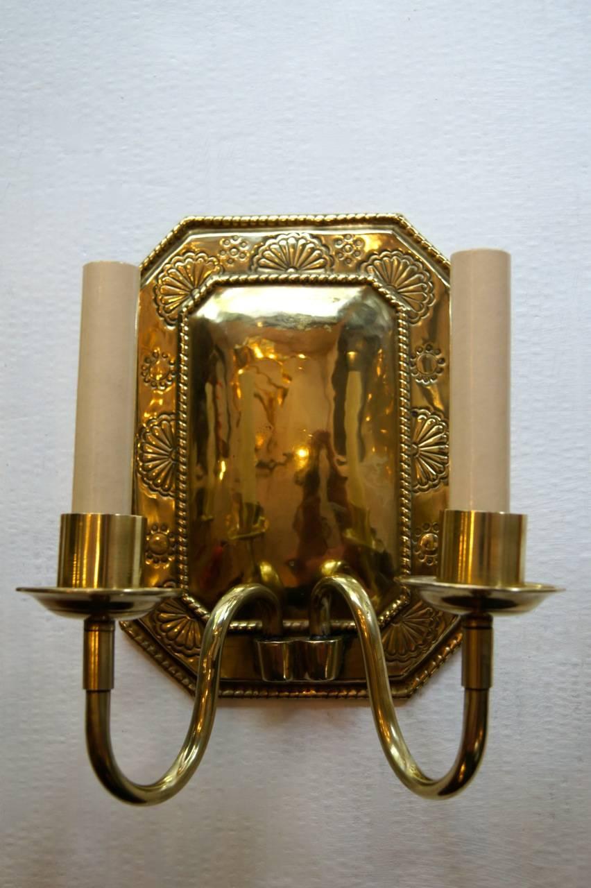 Pair of 1920s Swedish repoussé brass double light sconces with original patina.

Measurements:
Height: 9″.
Width: 8.5″.
Depth: 6″.