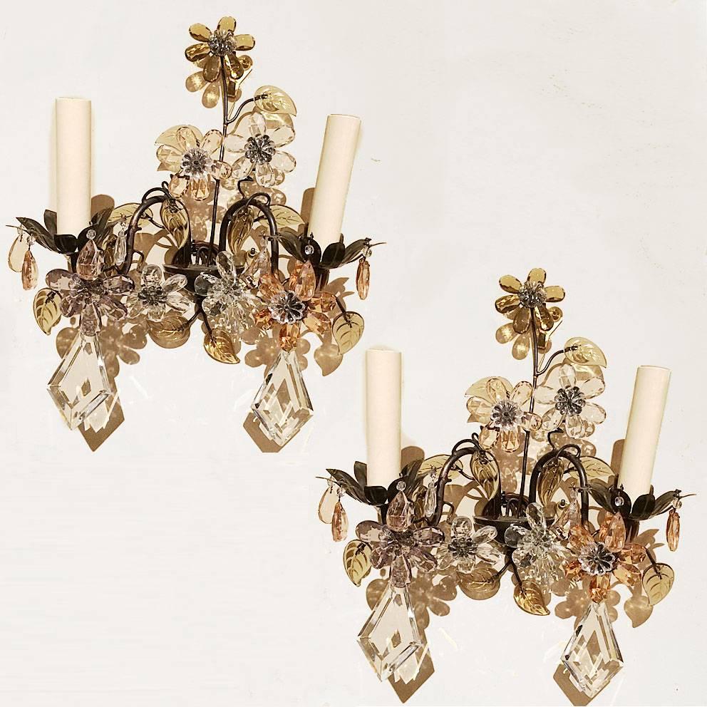 Pair of French circa 1930's two-arm sconces with amethyst, peach and clear crystal flowers. 

Measurements:
Height: 11
