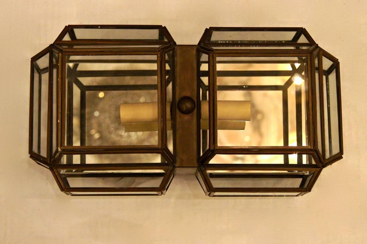 A set of eight, circa 1960s Italian rectangular brass and glass flush mounted light fixtures with mirror backs and two chandelier bulbs each. Sold individually.
 
Measurements:
Length: 13.5