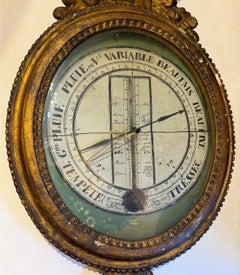 Barómetro antiguo de madera dorada de estilo neoclásico