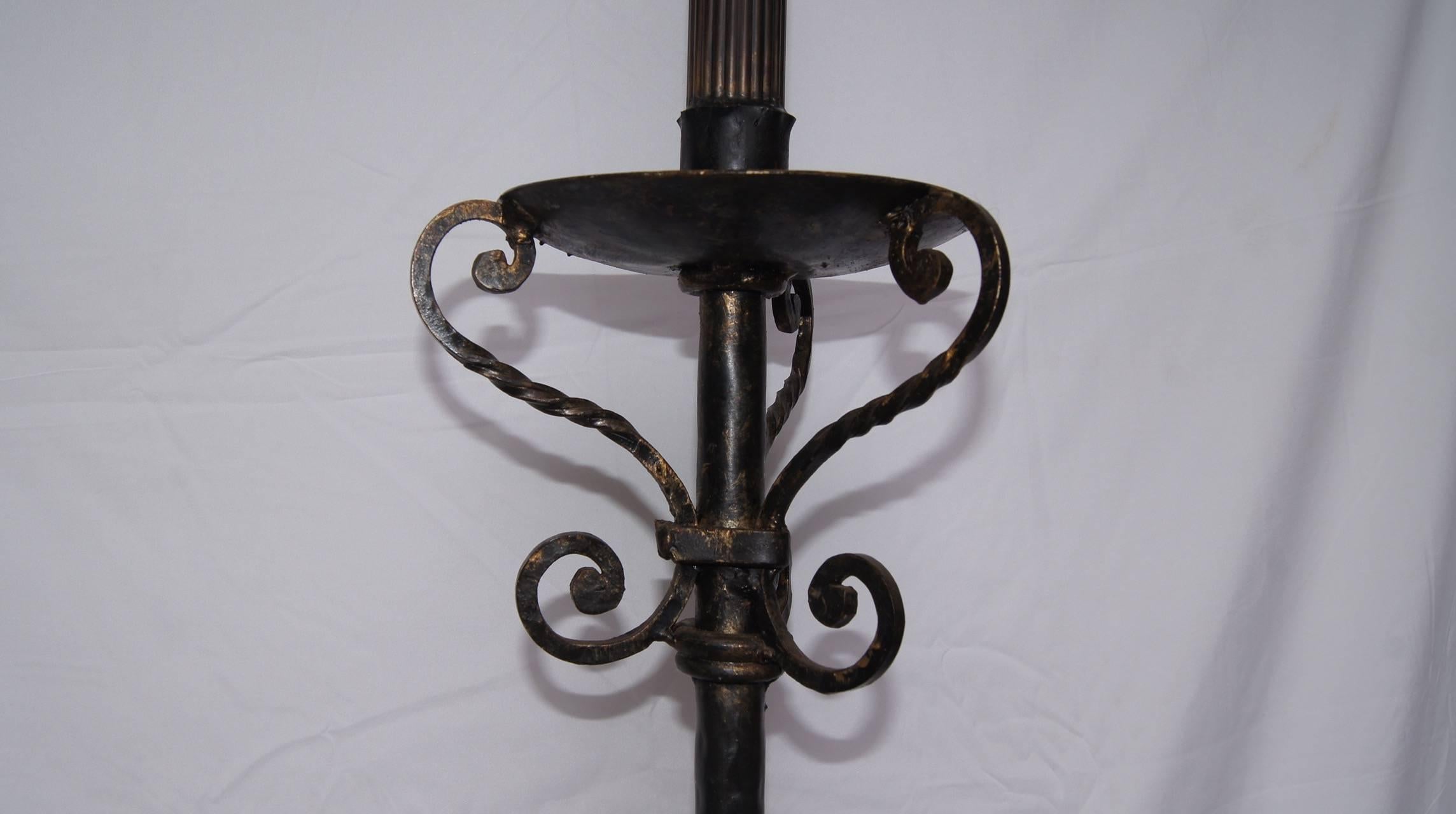 Pair of 1930s wrought iron floor lamps with hammered texture, scrolling motif on body and legs.

Height of body alone 50