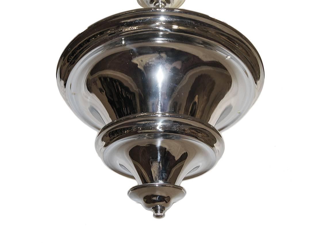 A pair of circa 1920's nickel plated light fixture with interior lights. Sold individually.

Measurements:
Height (drop): 28