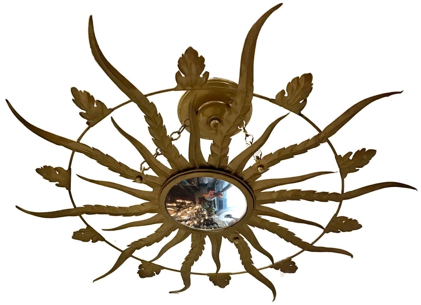 French, 1940s, gilt metal sunburst light fixture with convex mirror inset.
Measurements:
Diameter: 25