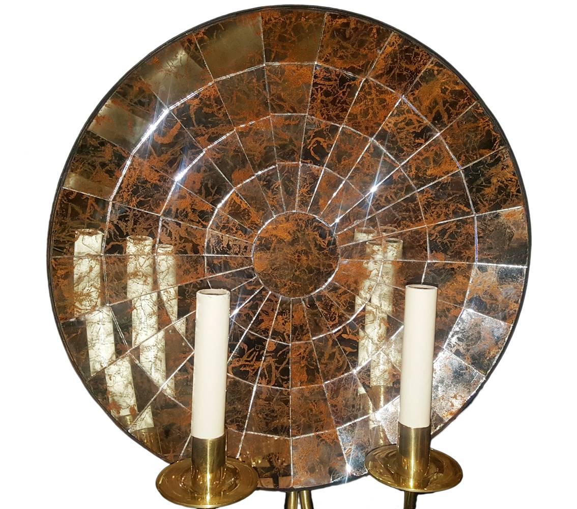 Pair of mirrored back sconces double light, polished brass body, mirror with slight gold patina, circa 1950s.

Measurements:
Height 17.5