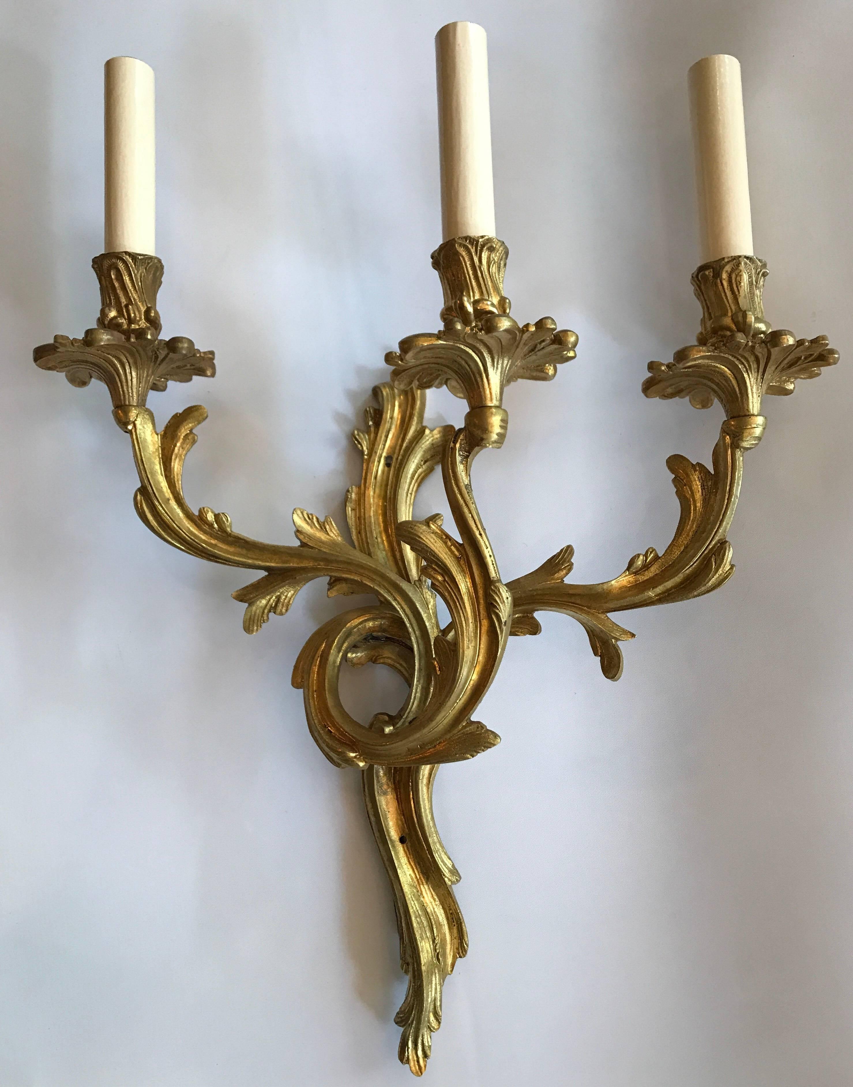 A pair of circa 1920s French Louis XVI style gilt bronze sconces with three lights.

Measurements:
Height 20
