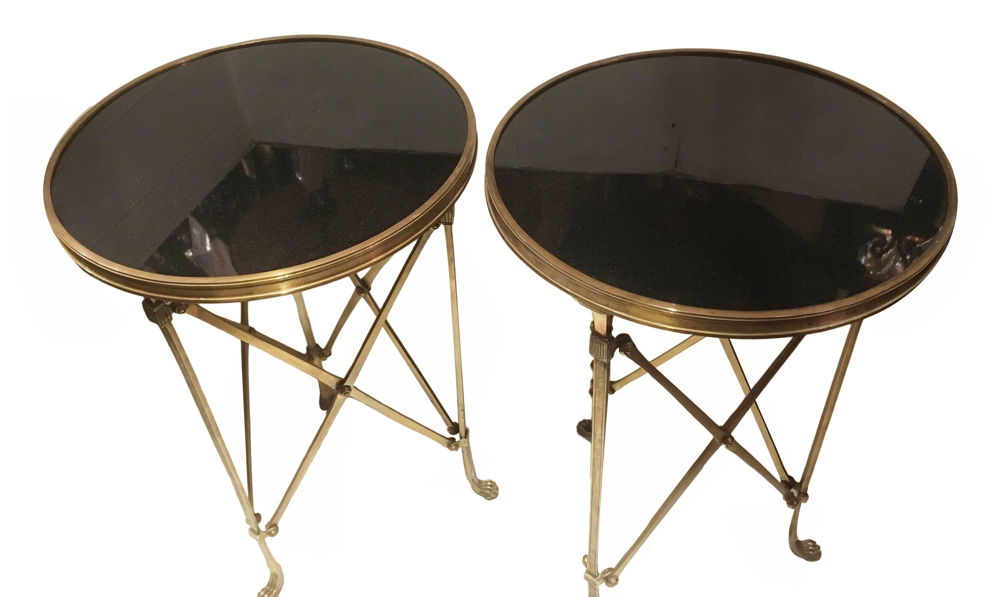Pair of 1950s French bronze side tables with black marble tops, tripod base with lion's paw feet.

Measures: 27 height, 17 diameter.

 