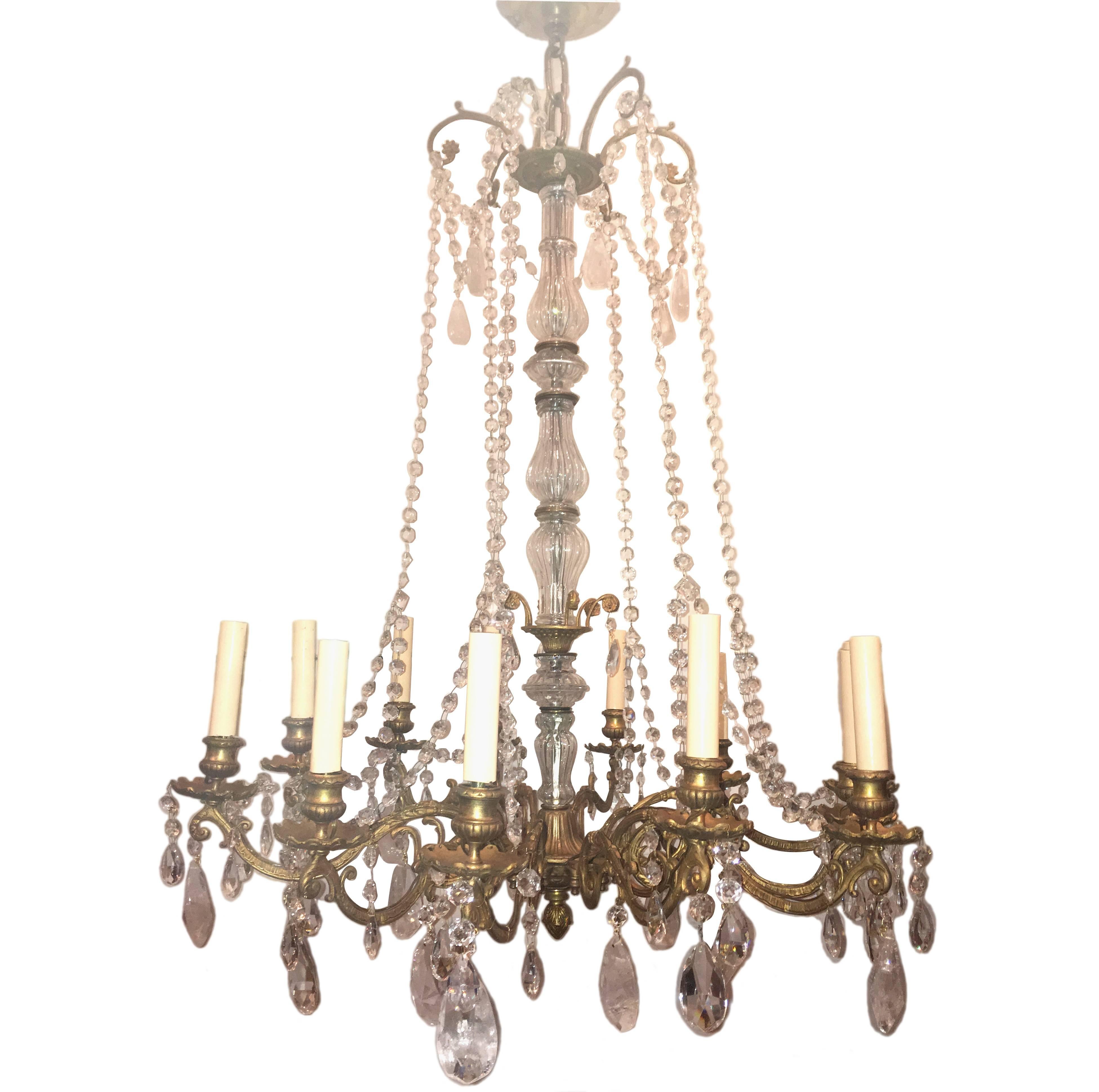 A twelve-arm English circa 1920 neoclassic style gilt bronze chandelier with foliage details on arms and body.

Measurements:
Drop: 38