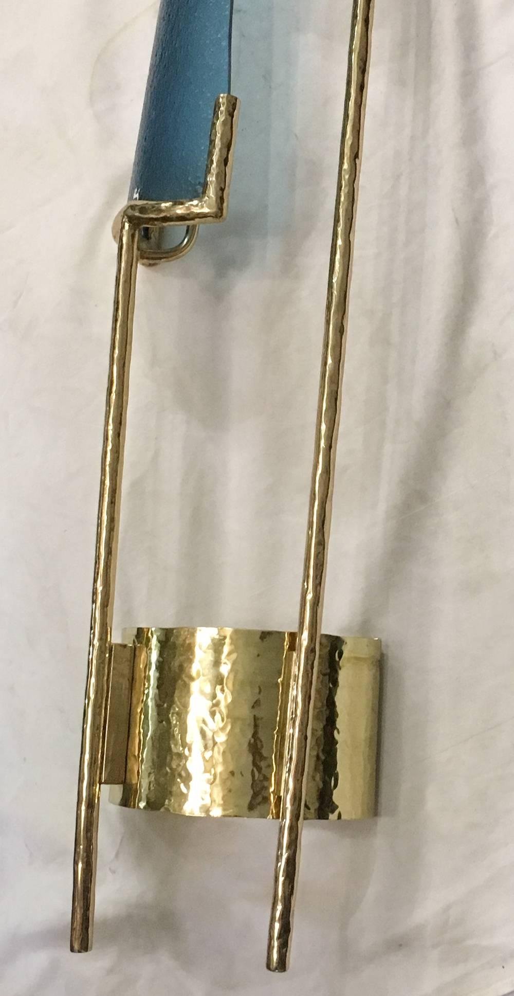 Pair of 1960s Italian polished bronze sconces with gilt finish and with large blue glass insets. Two lights each sconce.

Measurements:
58" height
9.5" length
5" depth.