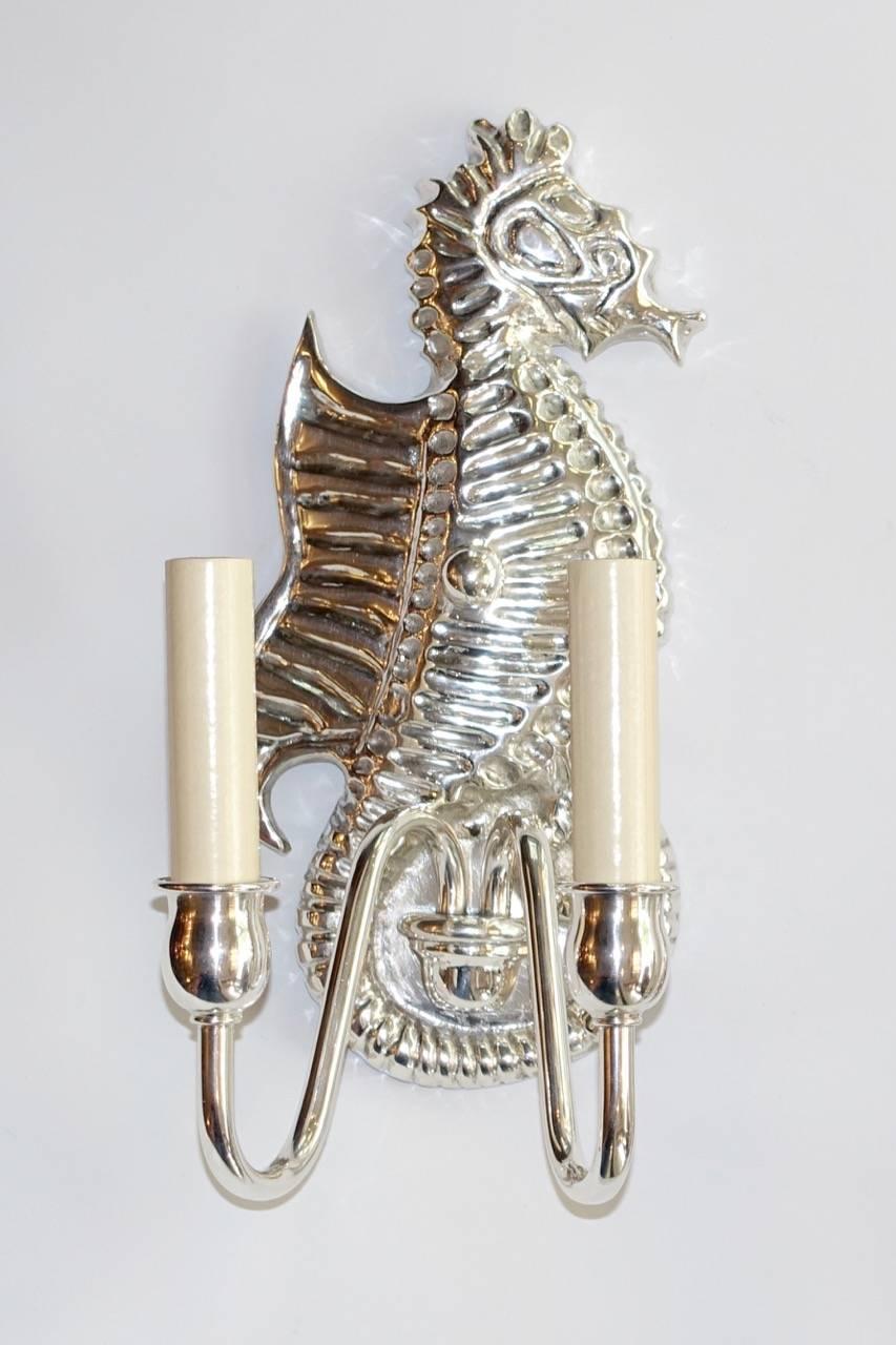 A pair of circa 1940s silver plated bronze sea horse two-light sconces.

Measurements:
Height 12