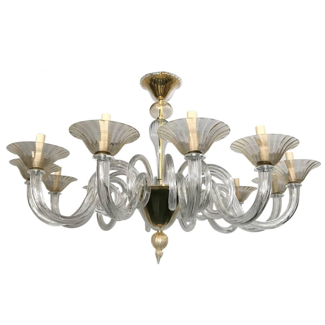 A circa 1960s Murano glass chandelier with clear and gold dust insets, 12 lights.

Measurements:
Diameter: 41.75
Minimum drop: 30