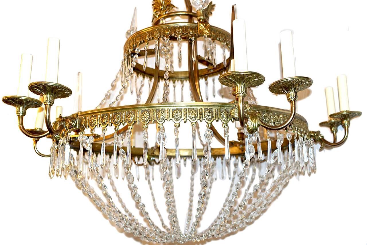 A large circa 1930s Swedish bronze and crystal chandelier with swags and delicate foliage motif on body. Crystal pendants. 

Measurements:
Diameter 42