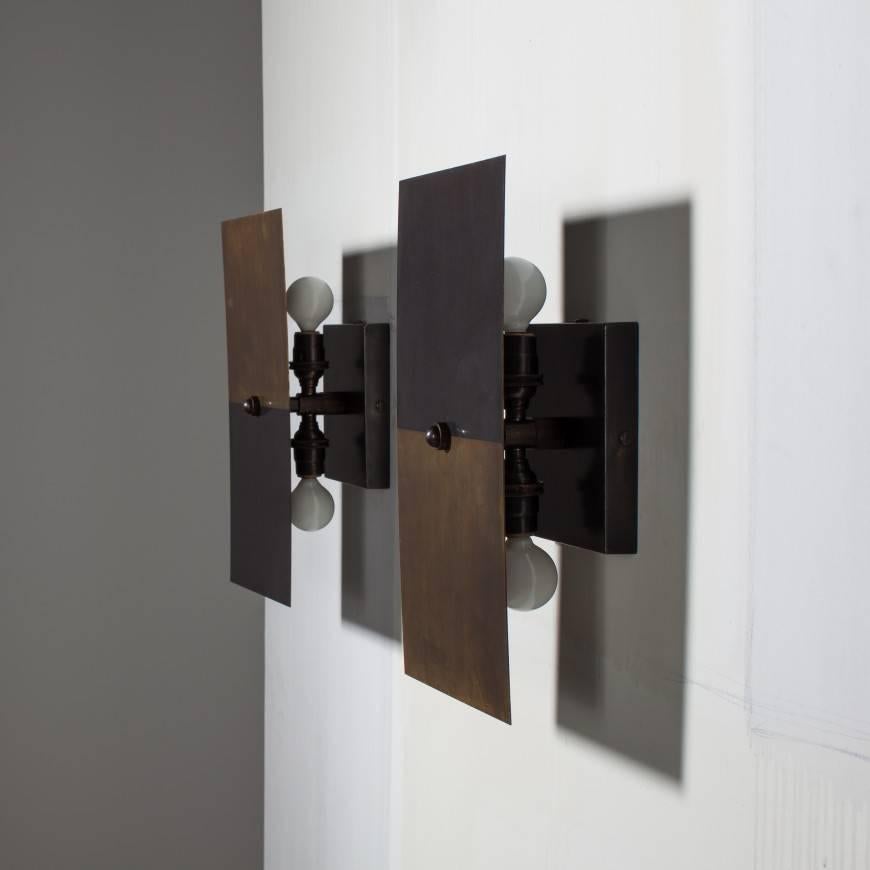 Designed to showcase the beauty and range of brass patinas, this sconce can be hung horizontally or vertically and pivots to direct a soft pool of light. Available in our signature two-tone, using a process developed in out studio to achieve dual