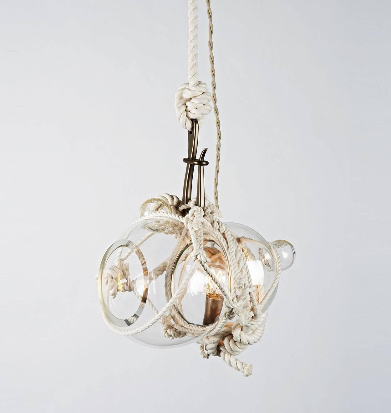 Heavily inspired by Japanese packaging and maritime culture, knotty bubbles is a sculptural light made of hand-blown glass globes tied together with knotted rope. The handmade nature of the knotty bubbles ensures that each is a unique piece.

Please