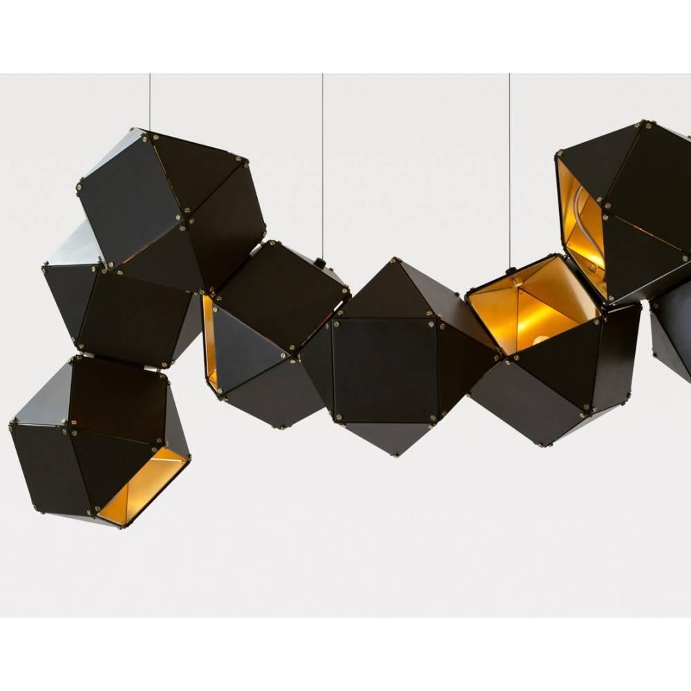 The Welles is a modular lighting system by Canadian design duo Gabriel-Scott. Polyhedra of blackened steel with interiors of brass, copper, or nickel are connected like molecules.

Pricing is for 12 cubes.  Custom options are available.