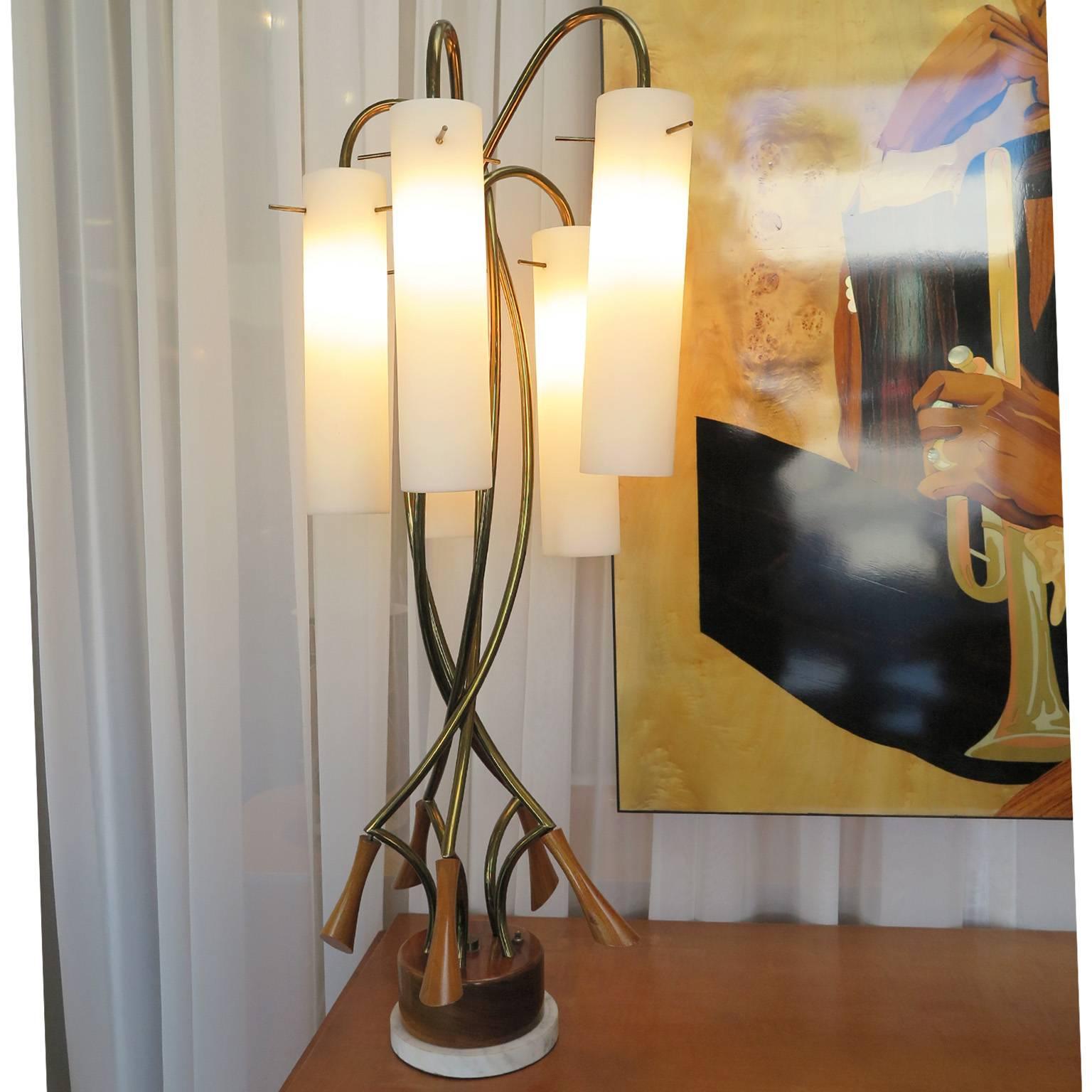 Twisted five-arm brass table lamp with frosted glass shades and set on a teak and marble base. Unique three hole attachment system of glass to frame. The lamp has three light settings and is striking in its large-scale and whimsical design.