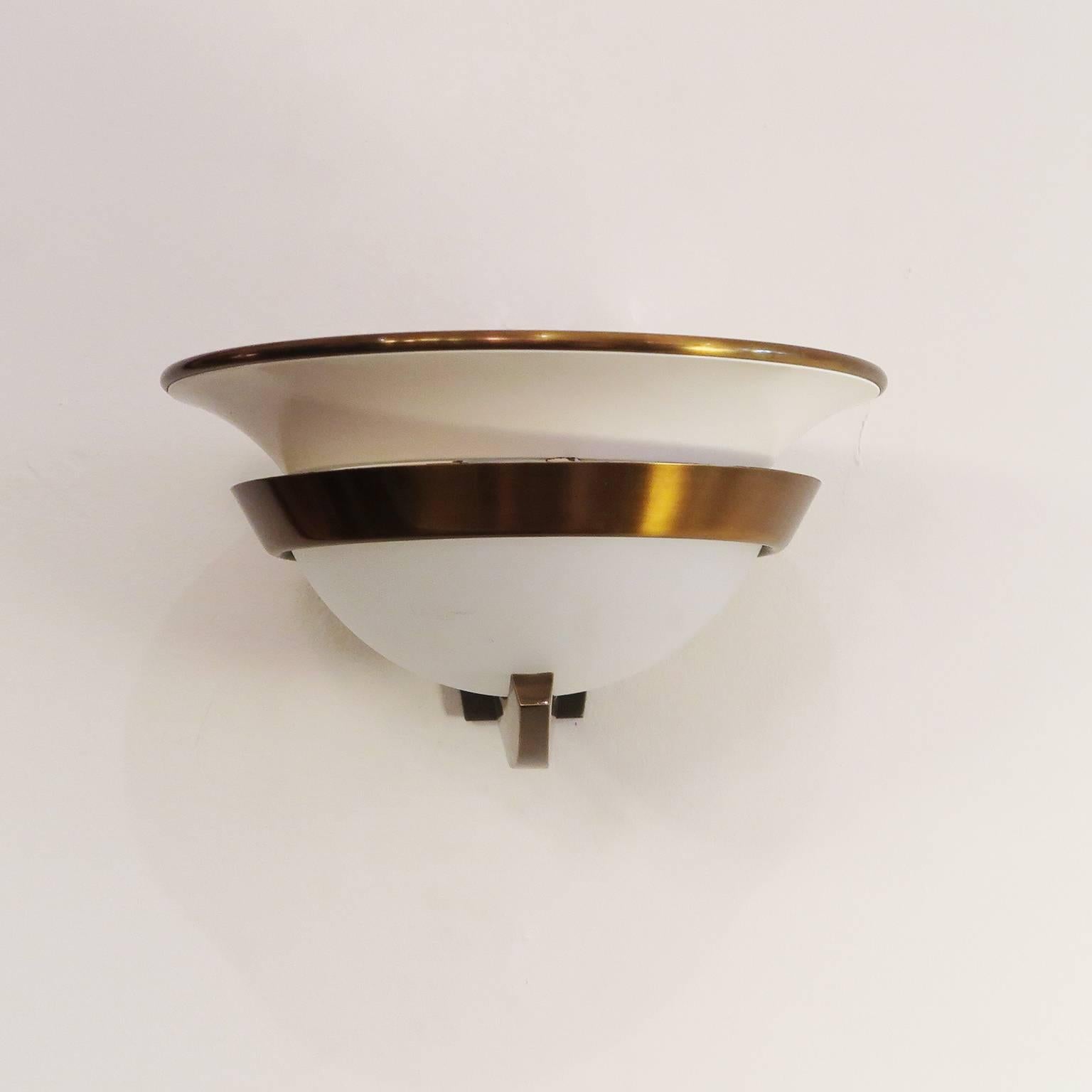 Pair of Art Deco sconces by Genet et Michon. Frosted glass bowl with ivory lacquer metal and brass details.