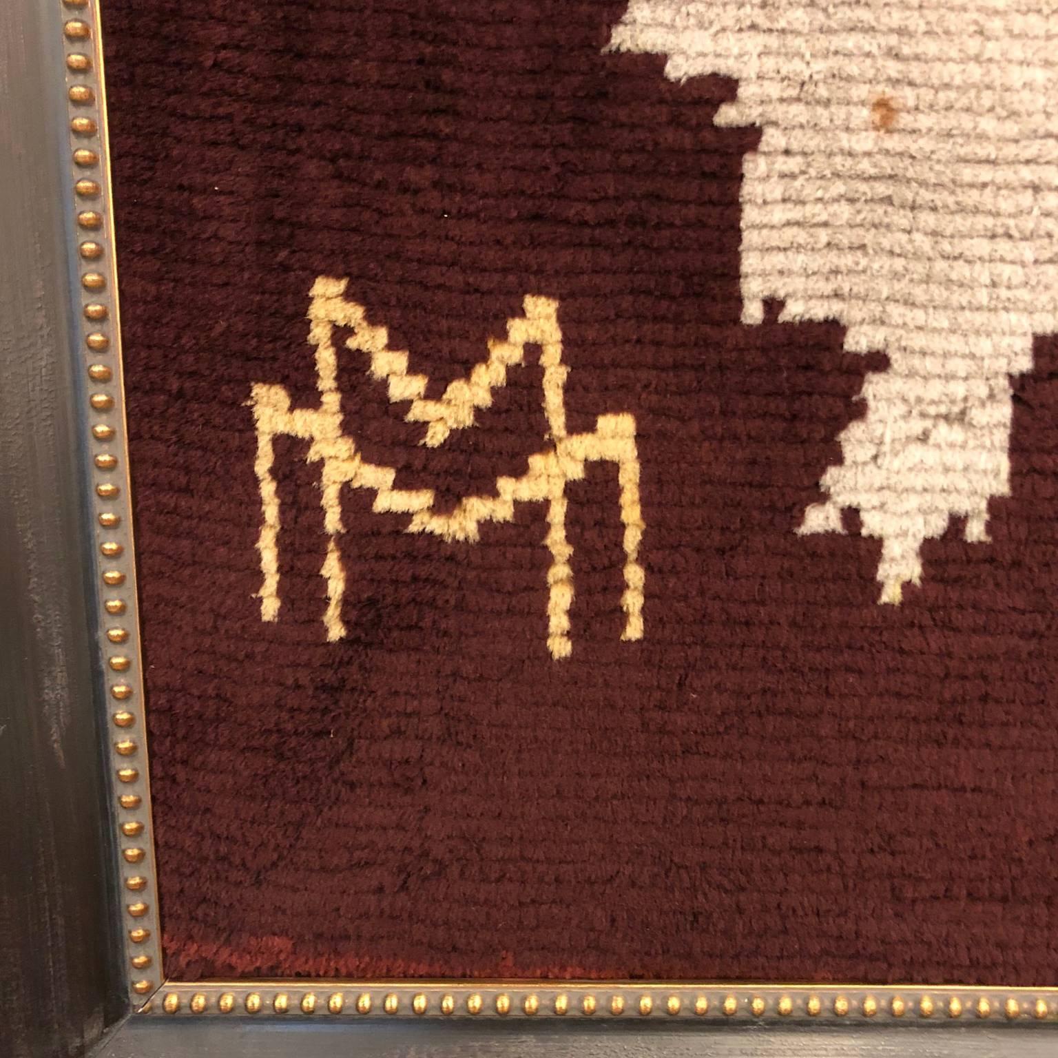 Hand woven wool rug hung as tapestry showing the Earth's continents, with a steamship and palm tree motifs in the corners. 
Newly framed in distressed black wood and gold dotted border

Attributed Maison DIM, Signed 
